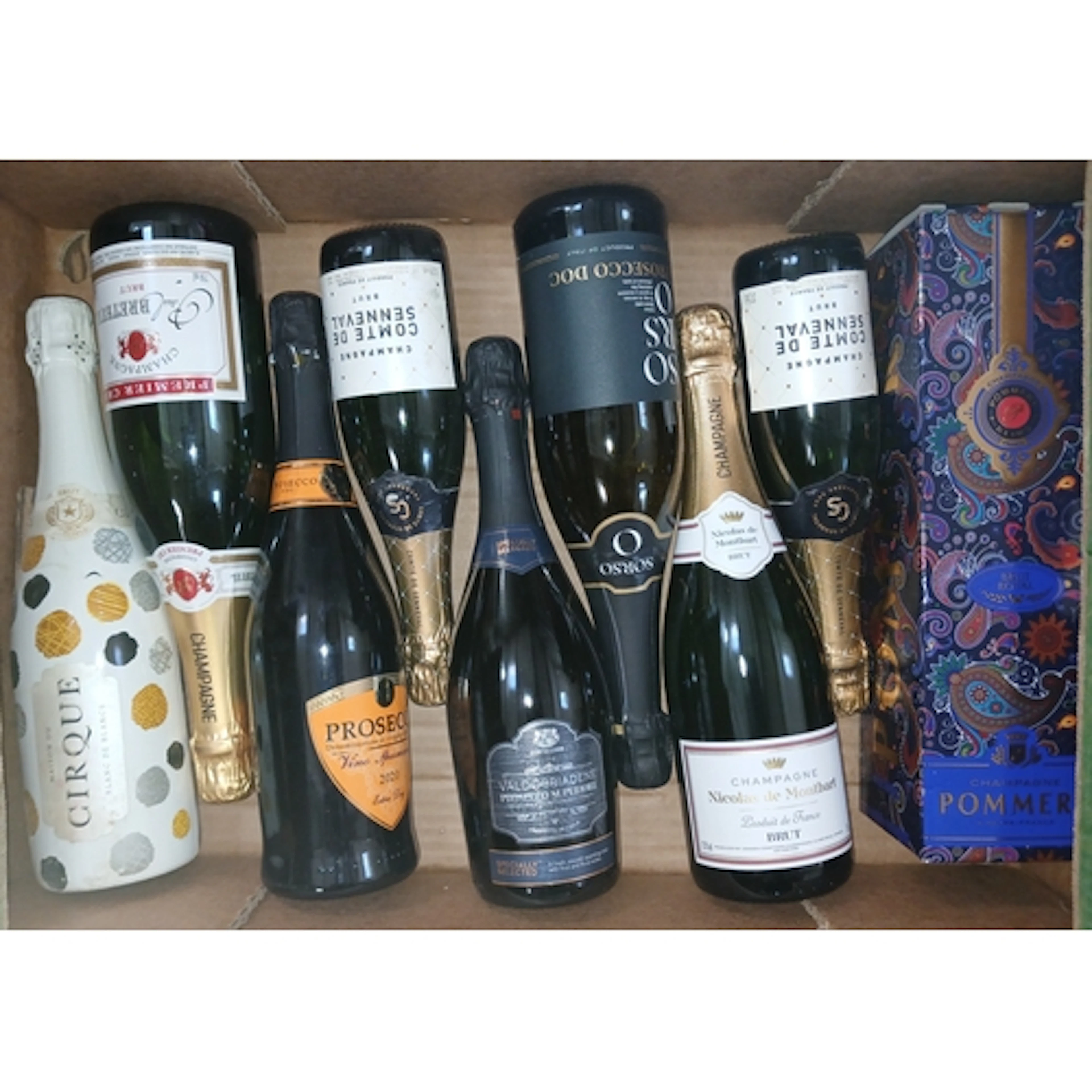 Nine bottles of assorted sparkling wine.