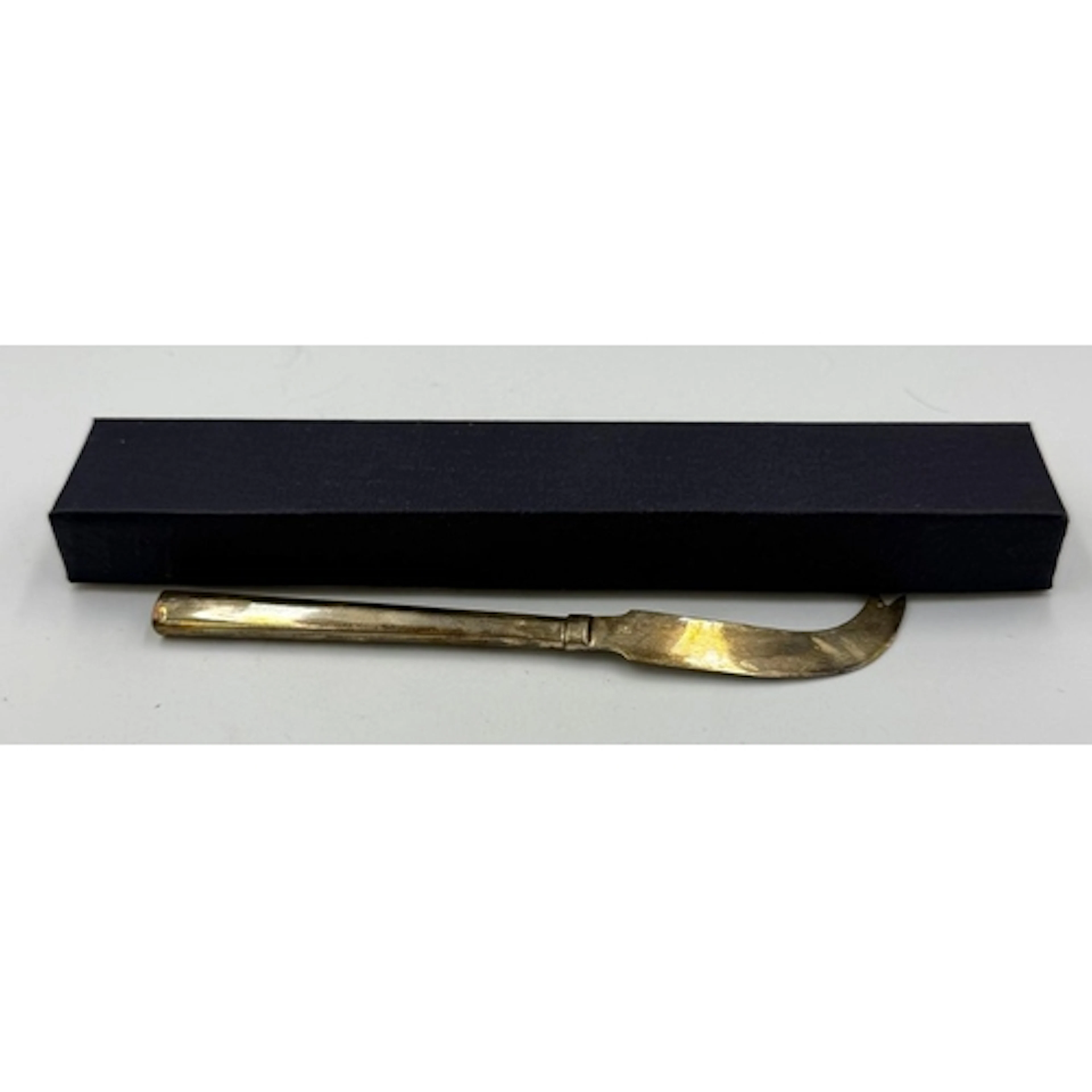 A boxed silver cheese knife
