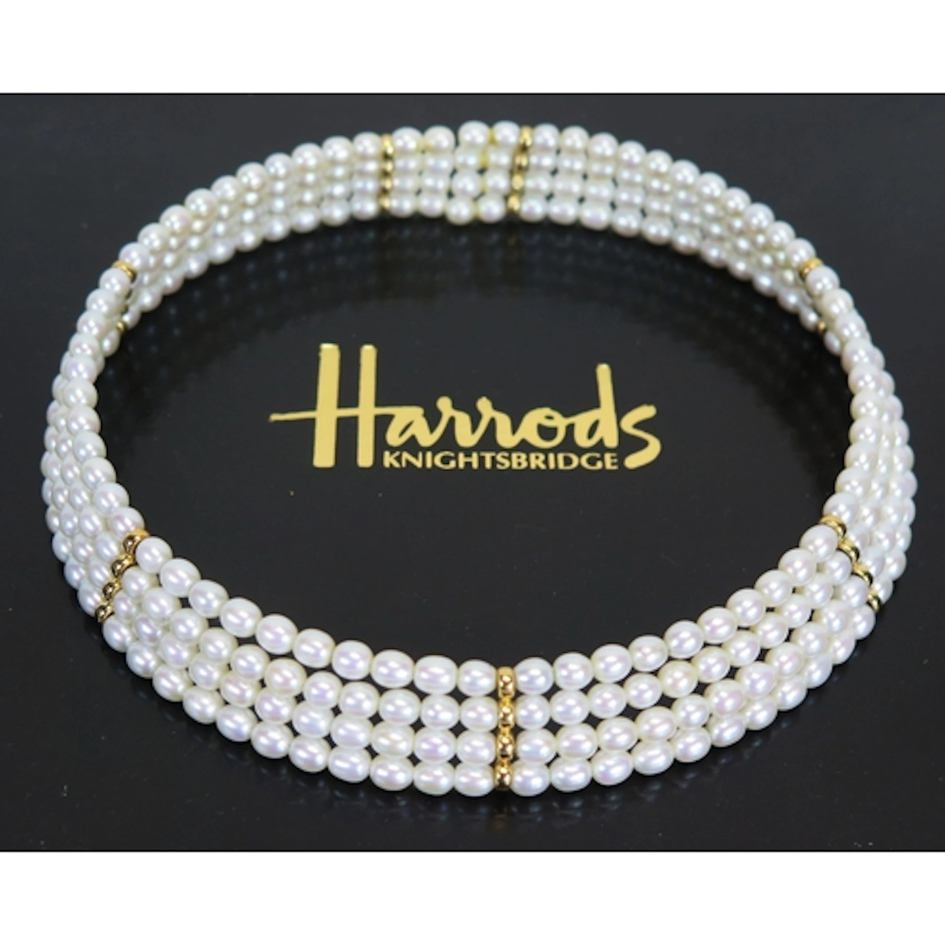 A Harrods fresh water pearl and yellow metal collar in Harro...