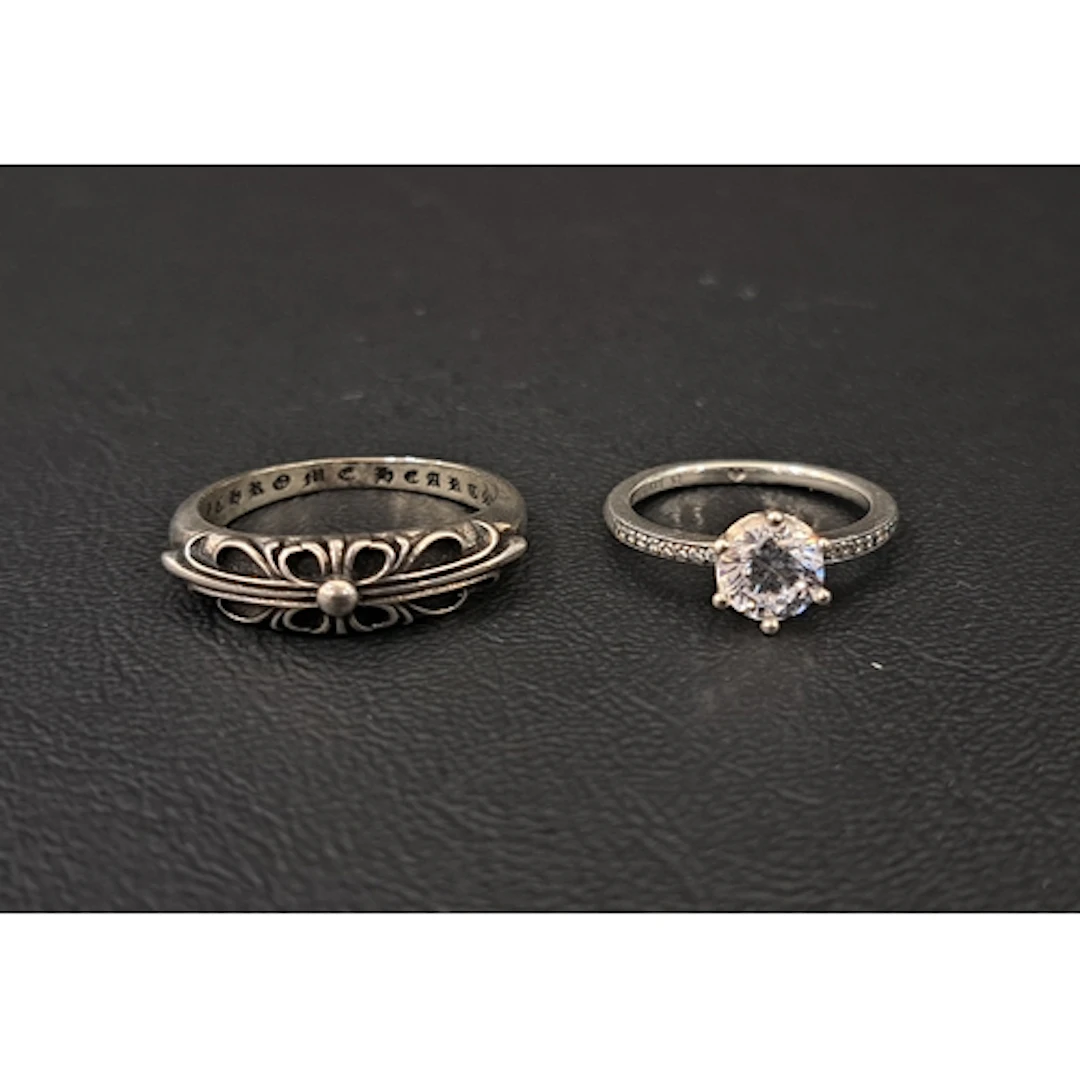 TWO FASHION JEWELLERY RINGS comprising a Chrome Hearts Silve...