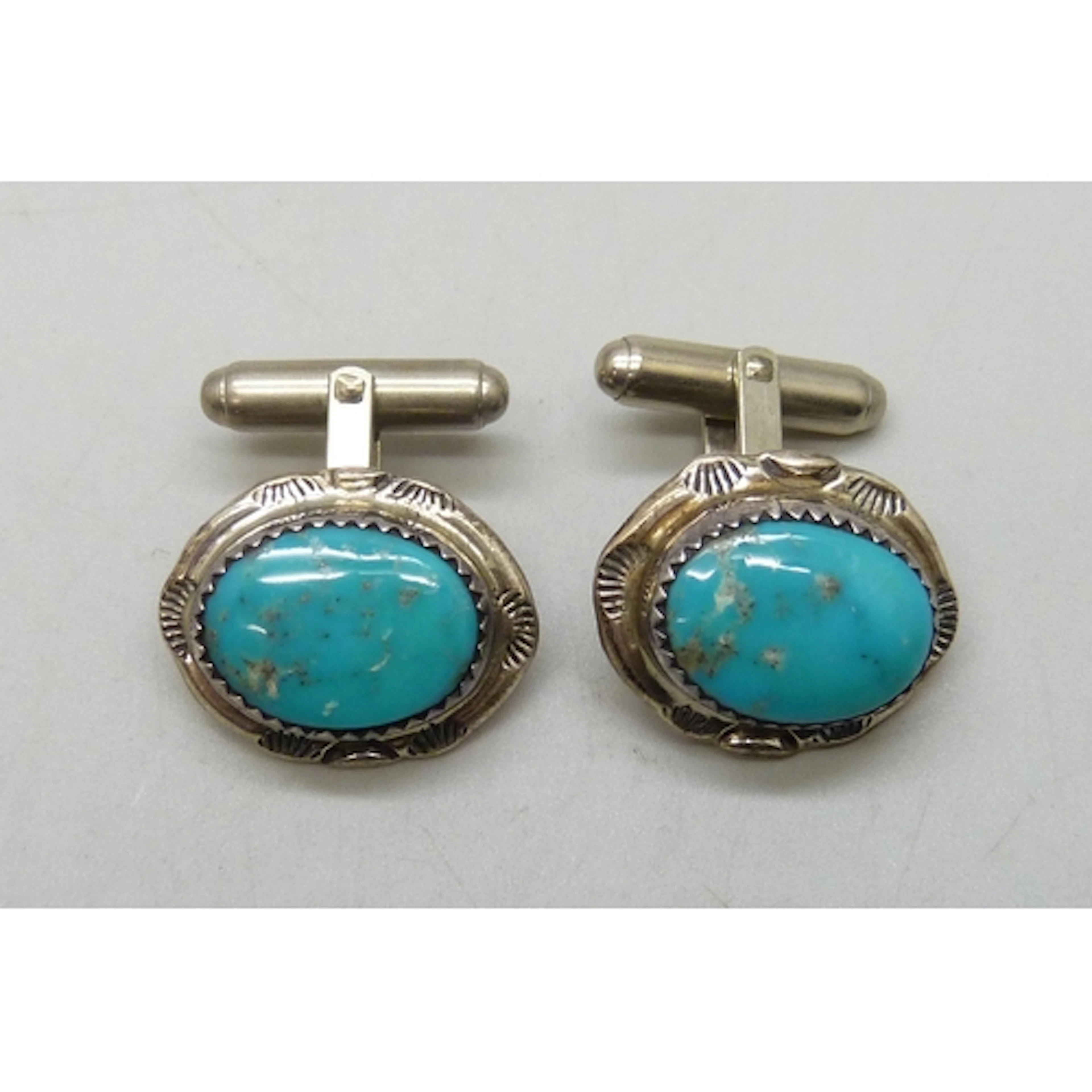 A pair of Navajo silver and turquoise cufflinks, marked TT s...