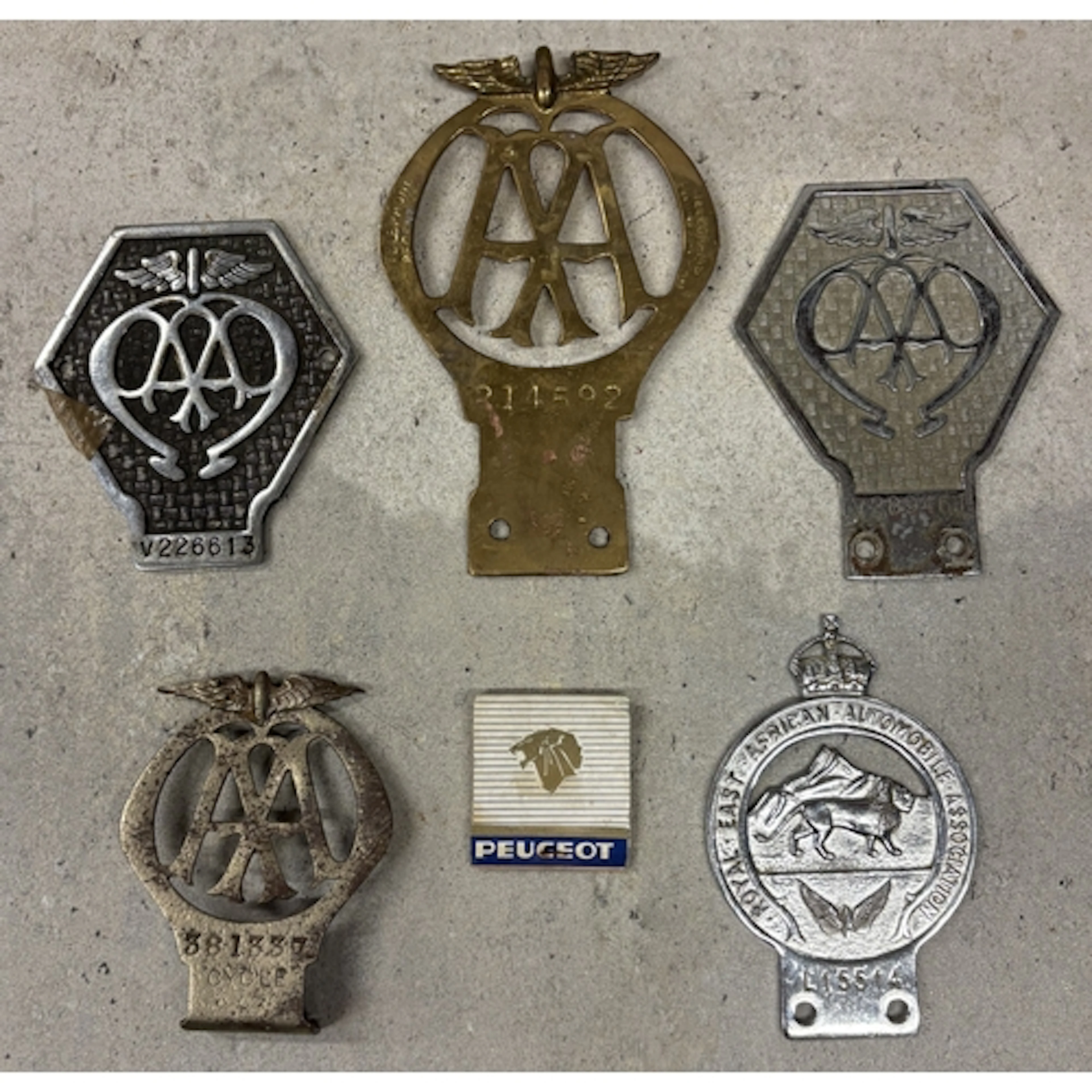 A pre 1930 AA motorcycle badge together with a brass AA badg...