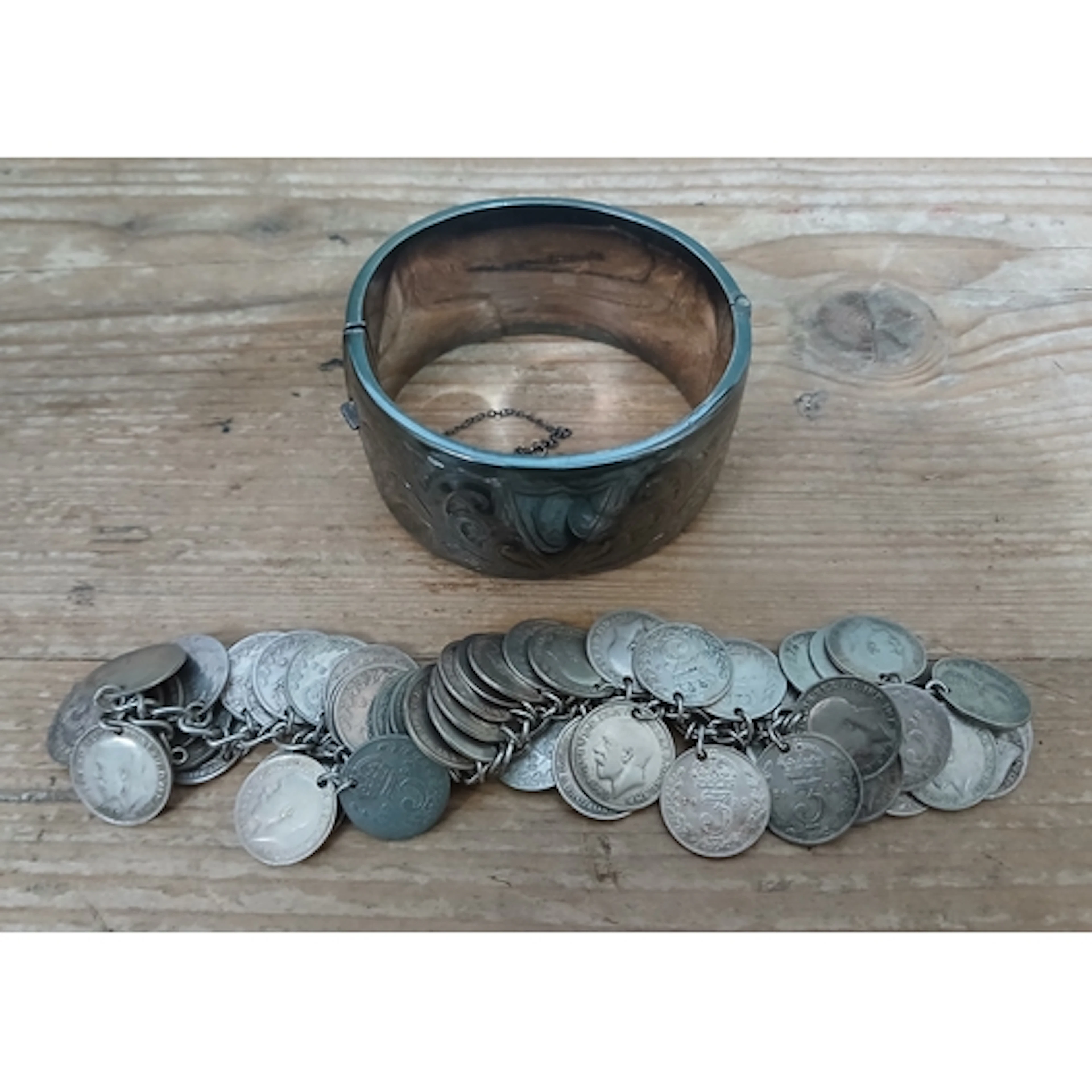 A hallmarked silver bangle and a coin bracelet, gross weight...
