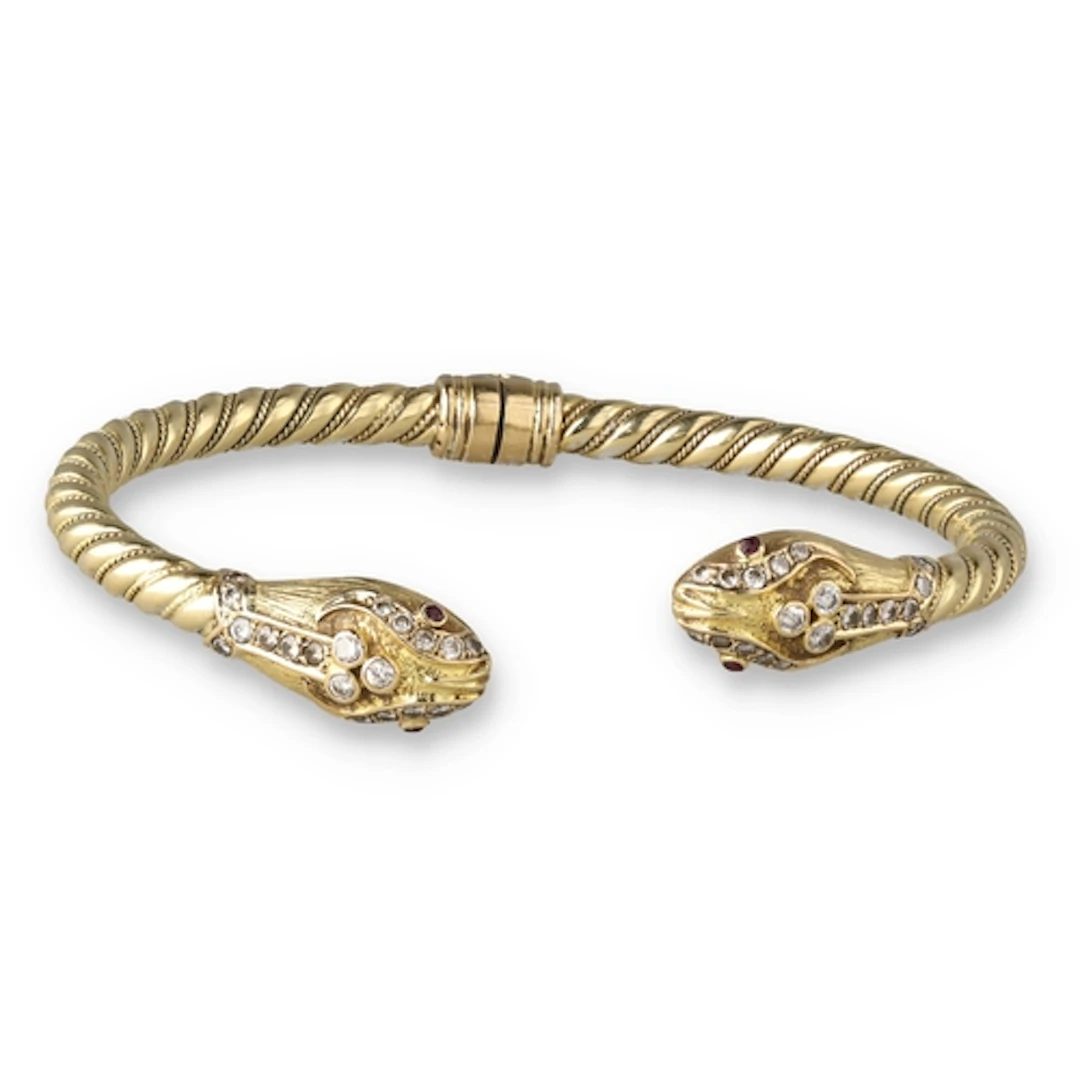 A YELLOW GOLD DIAMOND INCRUSTED SNAKE BANGLE Signed, hallmar...