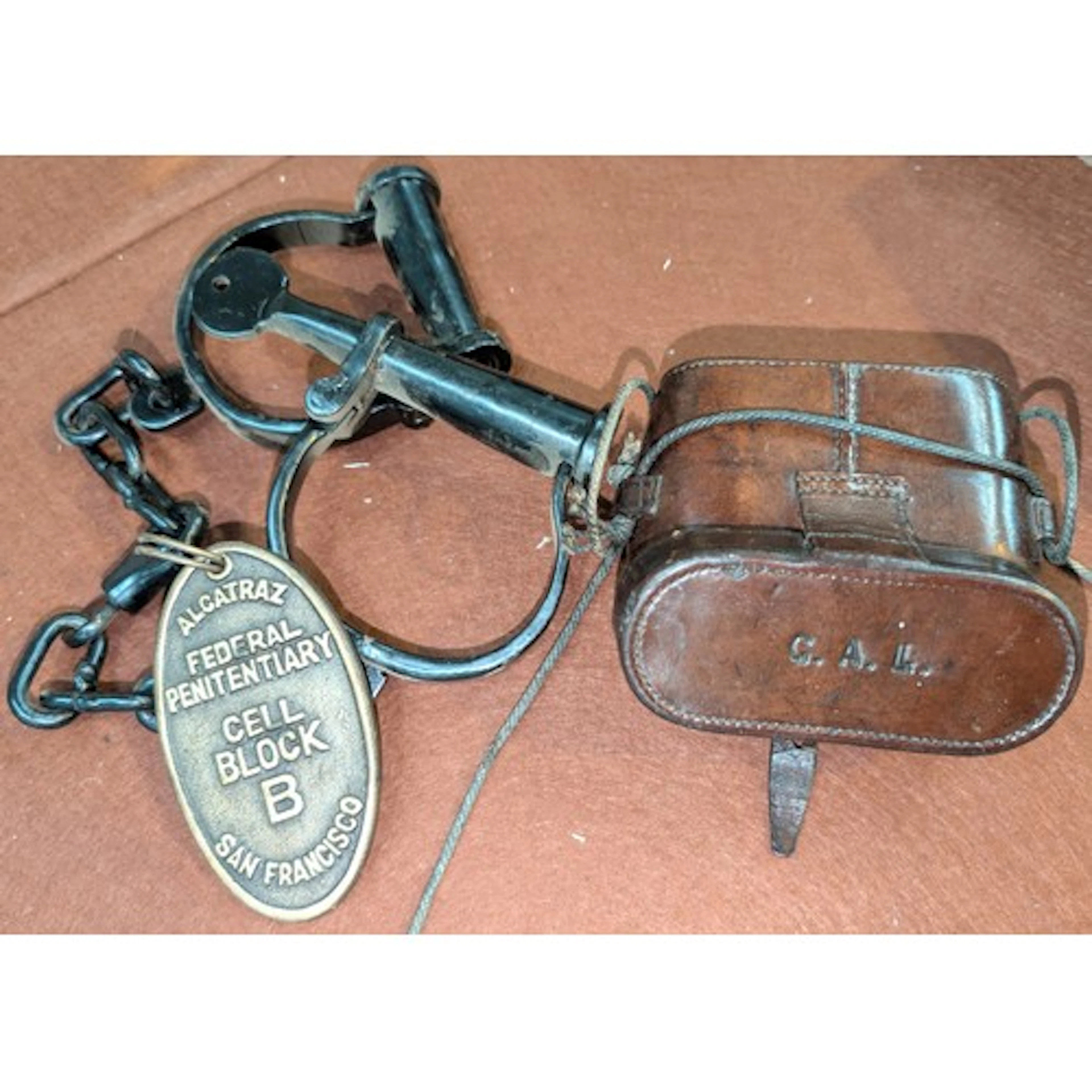 A replica pair of Alcatraz hand cuffs and a vintage cased pa...