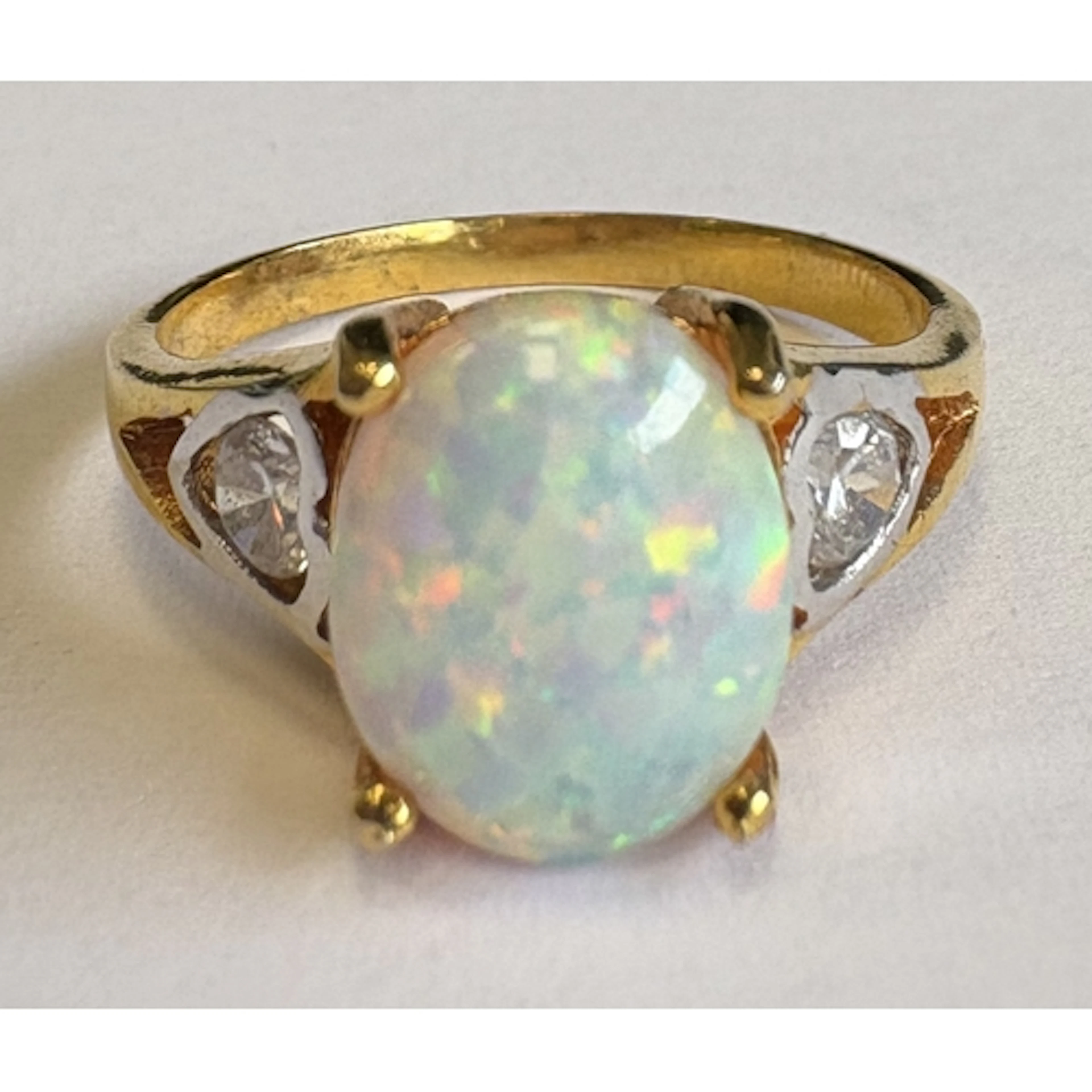 A small three-stone opal ring in claw mount. Approx. ring si...