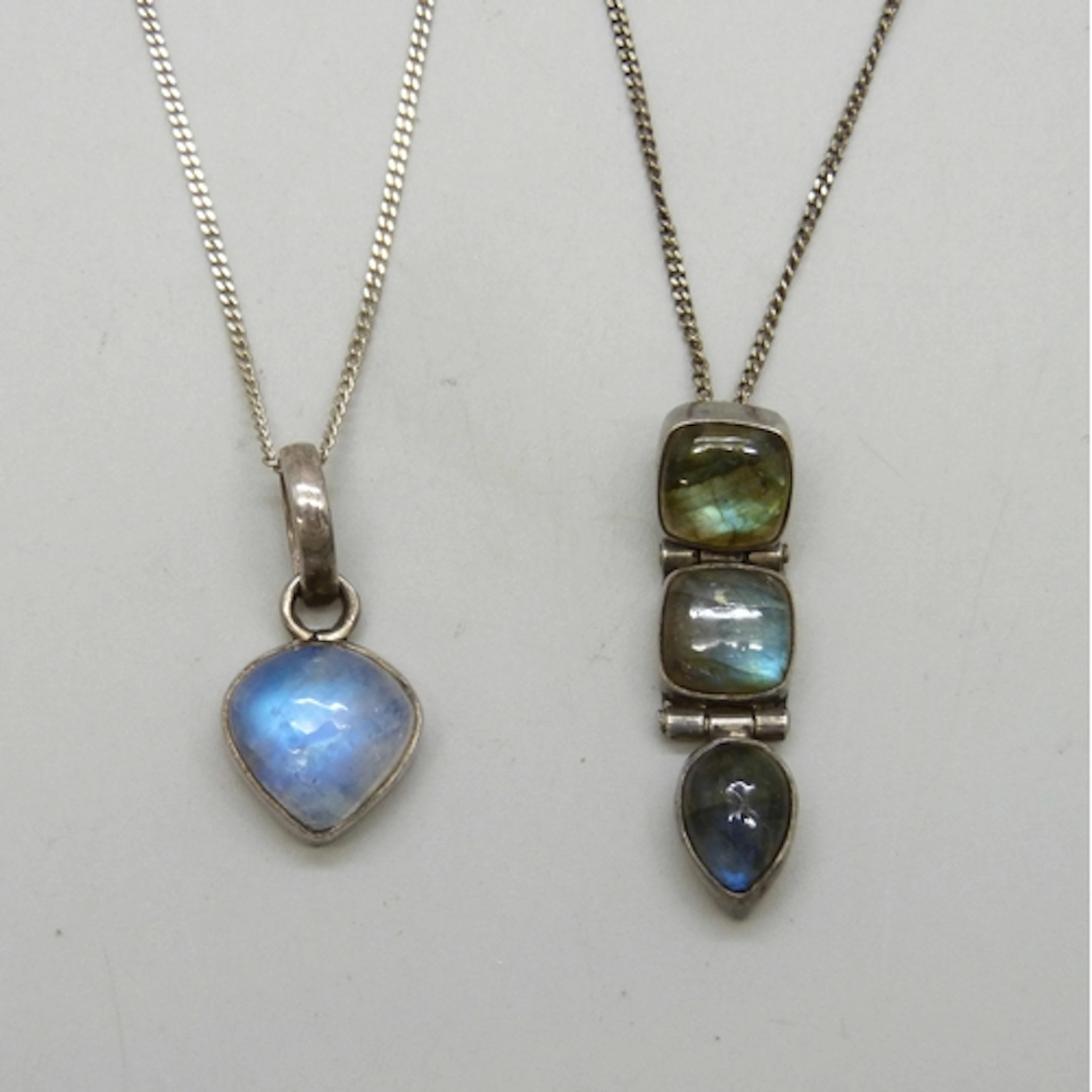Two silver necklace pendants on silver chains, moonstone and...
