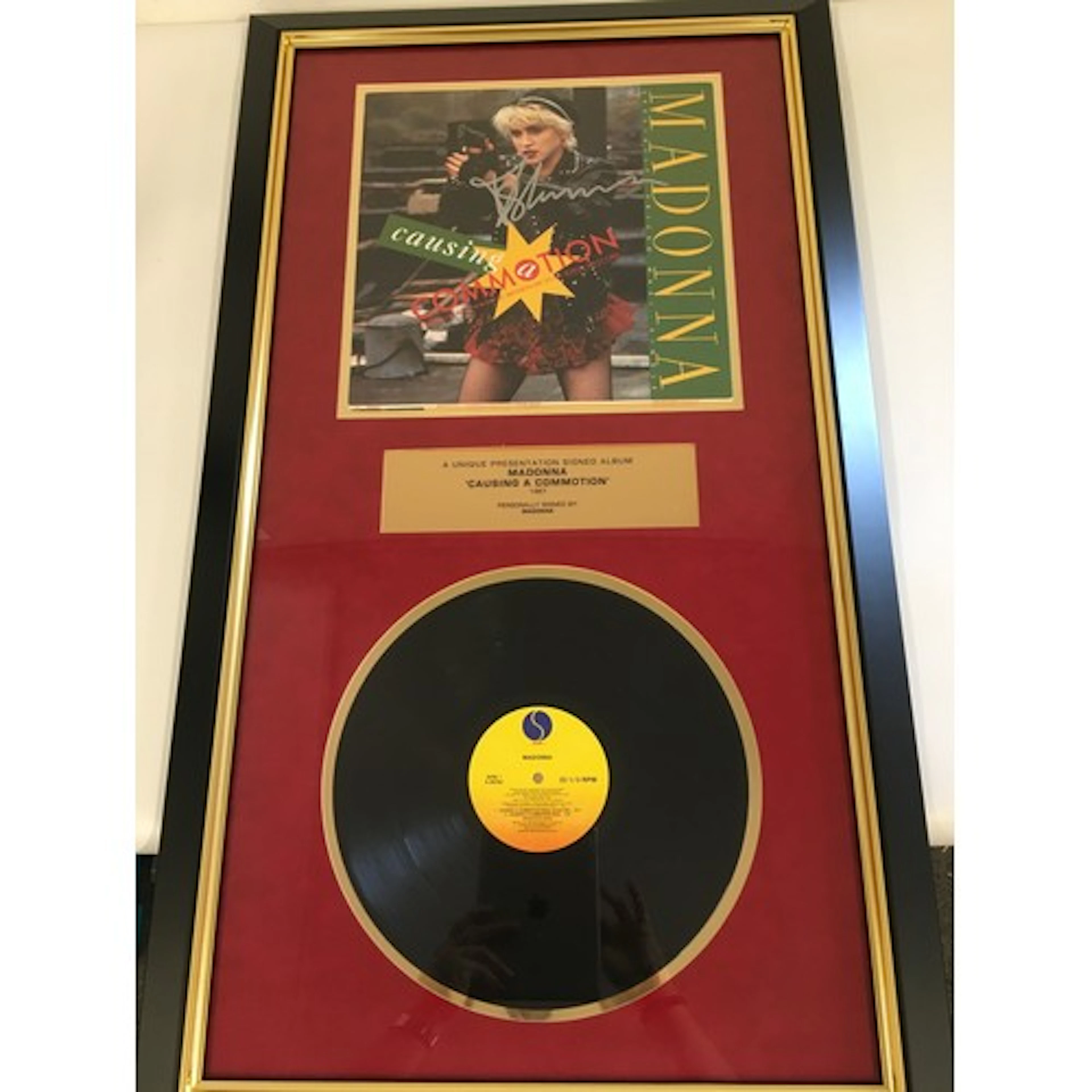 A framed and signed Madonna presentation display for the Cau...