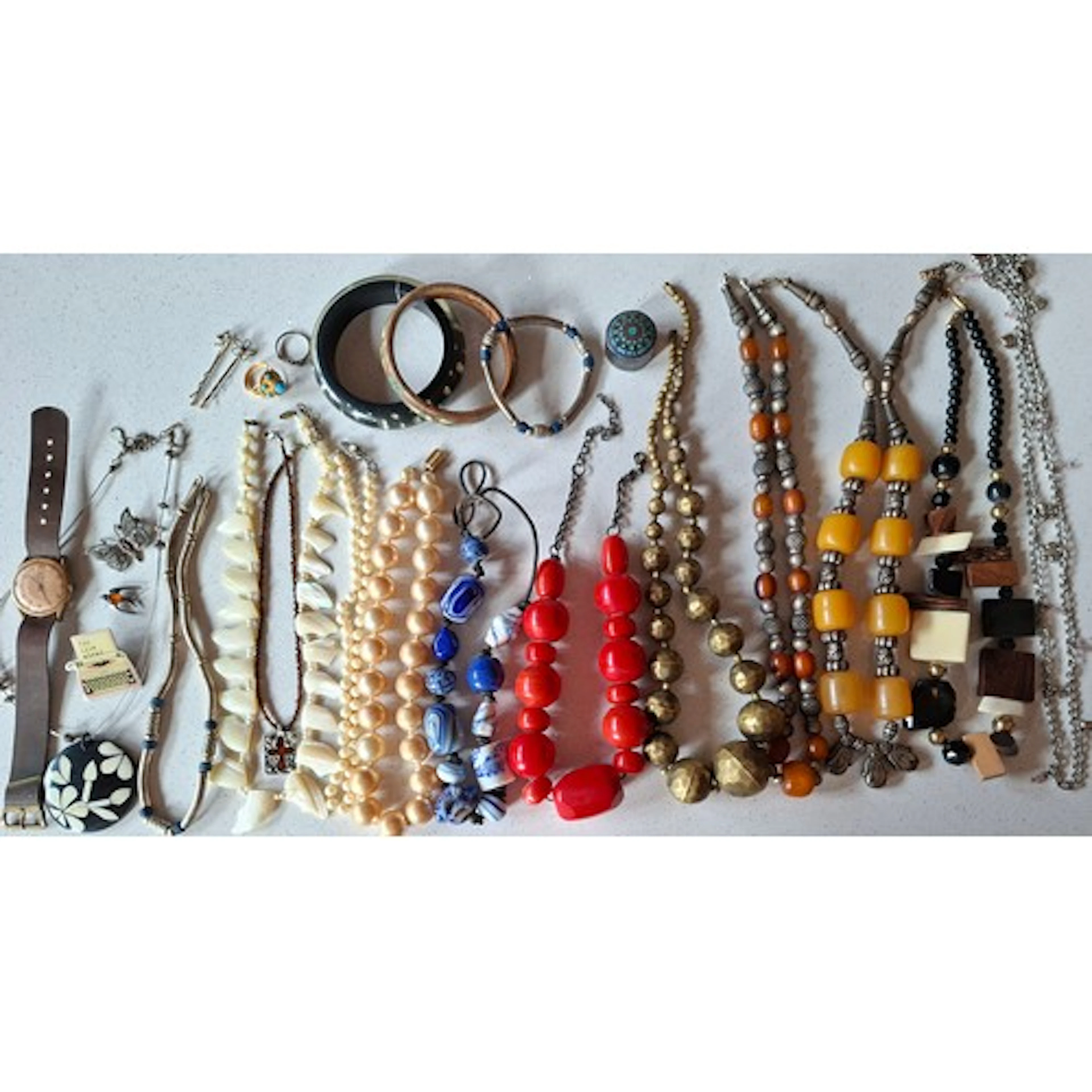 A quantity of costume jewellery to include 2 tribal metal an...