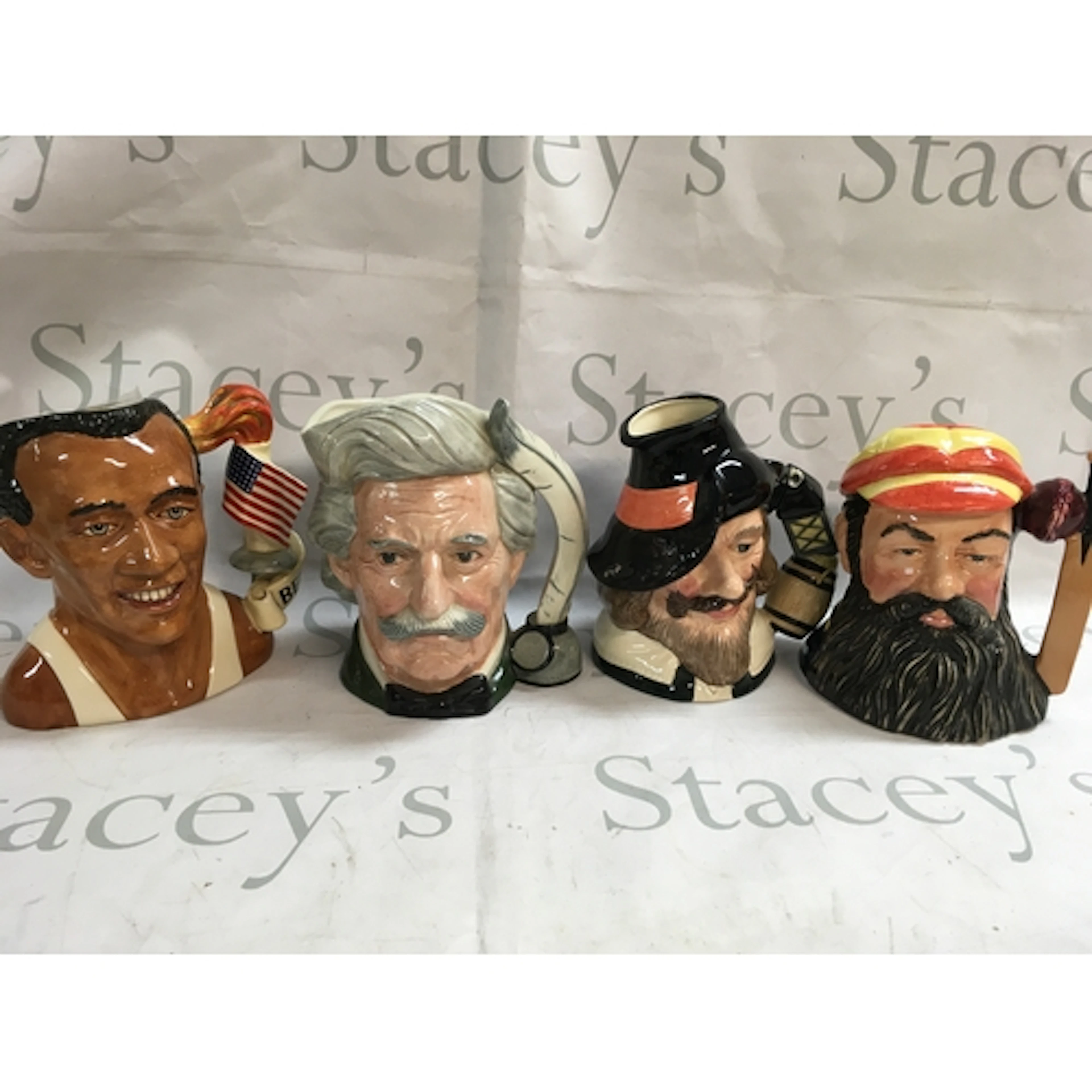 A collection of 4 Doulton character jugs including Jesse Owe...