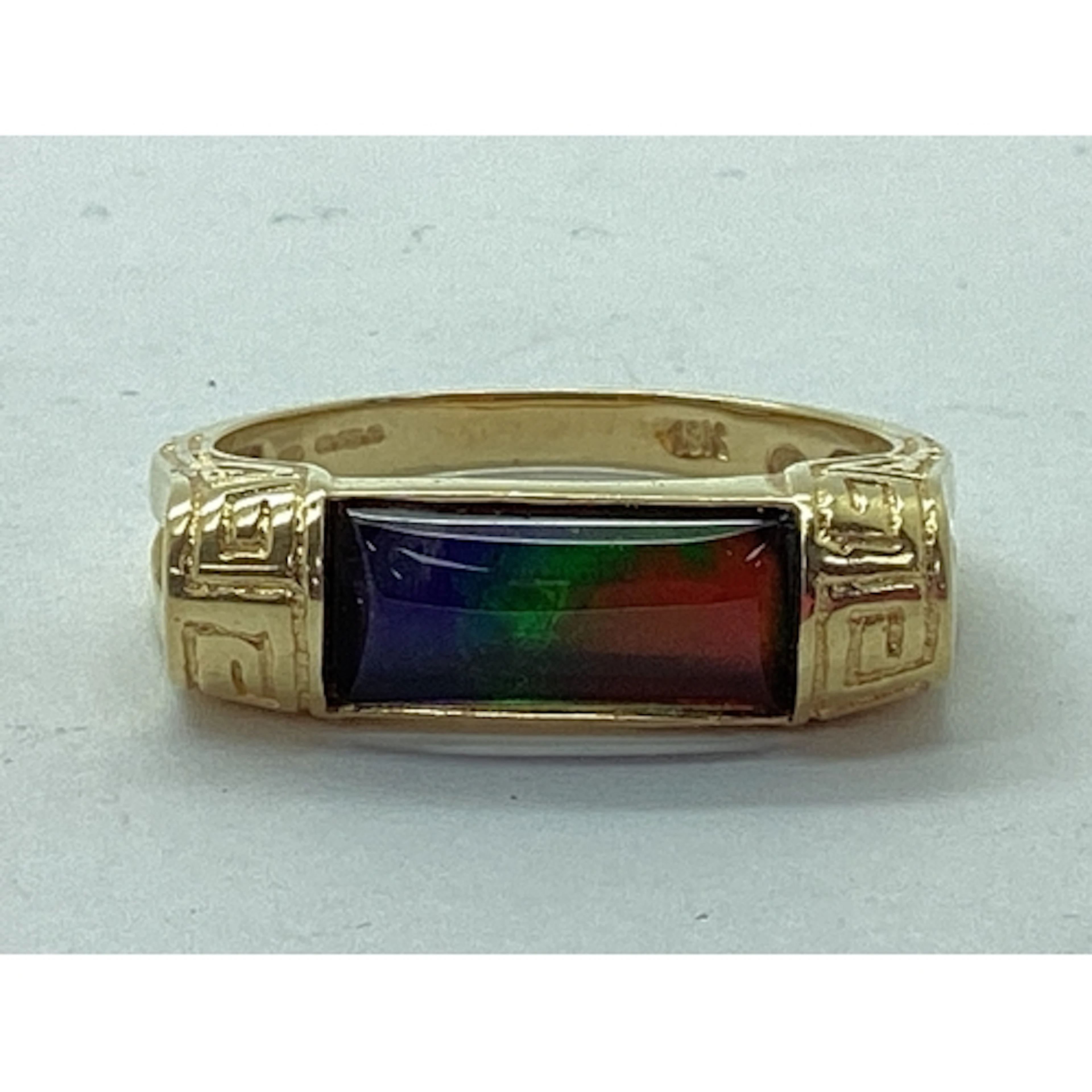 Korite; An Ornate Ammolite Set Ring, the elongated panel sem...