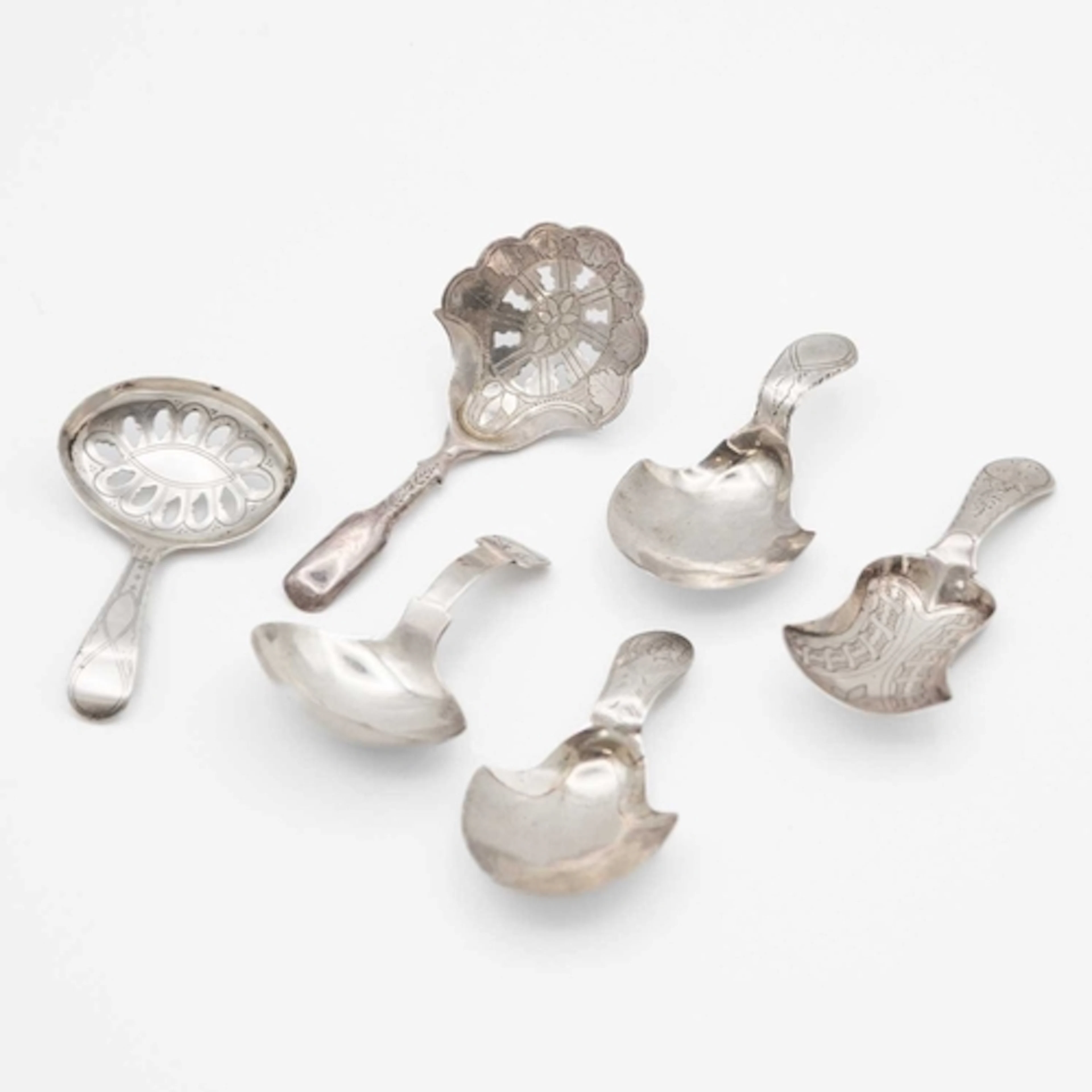 A collection of six various George III silver caddy spoons, ...