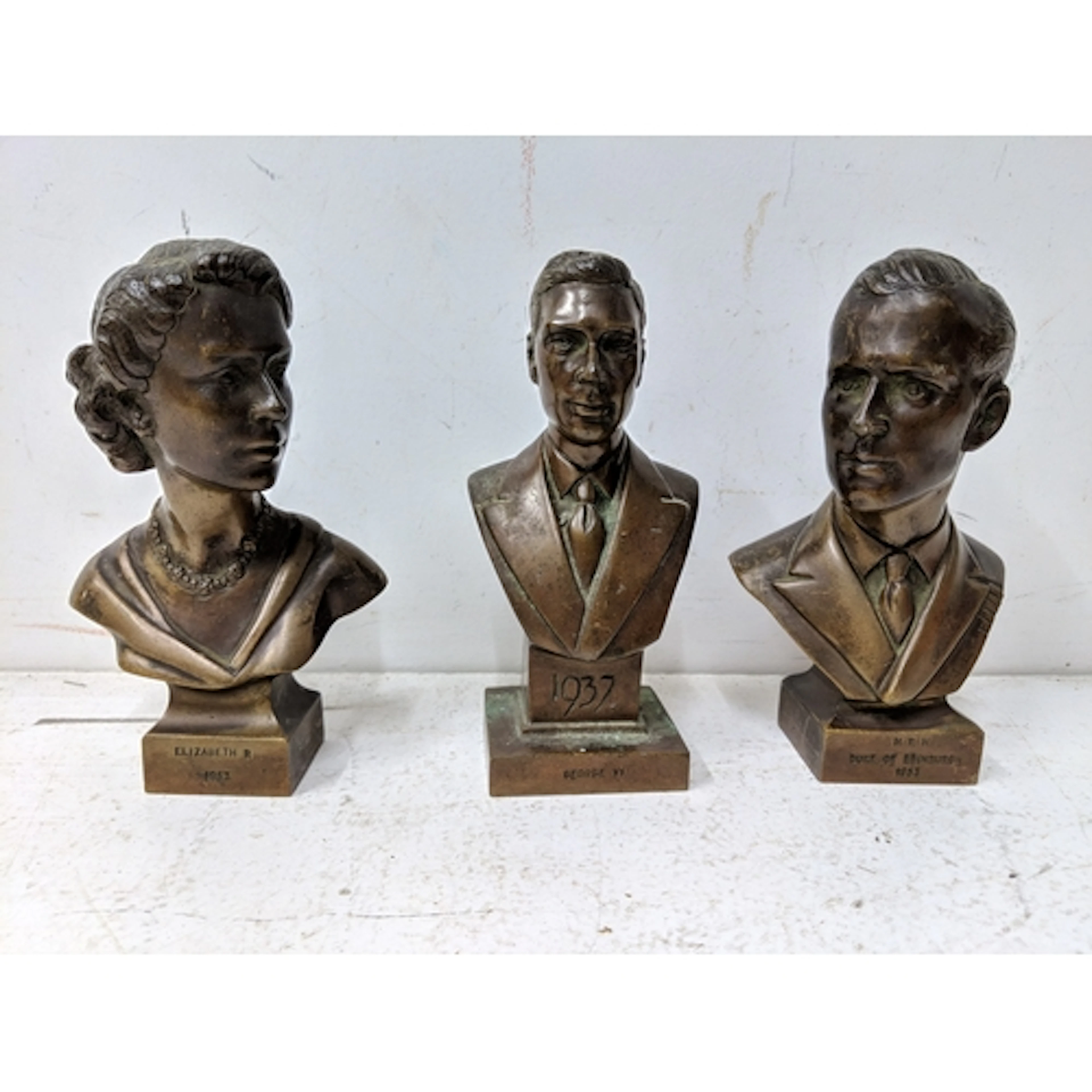 Three bronze busts, one of Queen Elizabeth, one of George Vi...