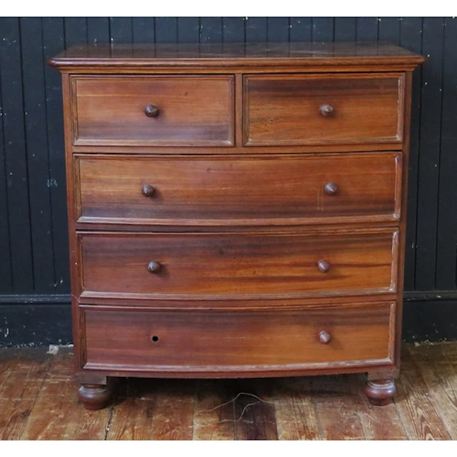 A mahogany bow front chest of drawers, with two short and th...