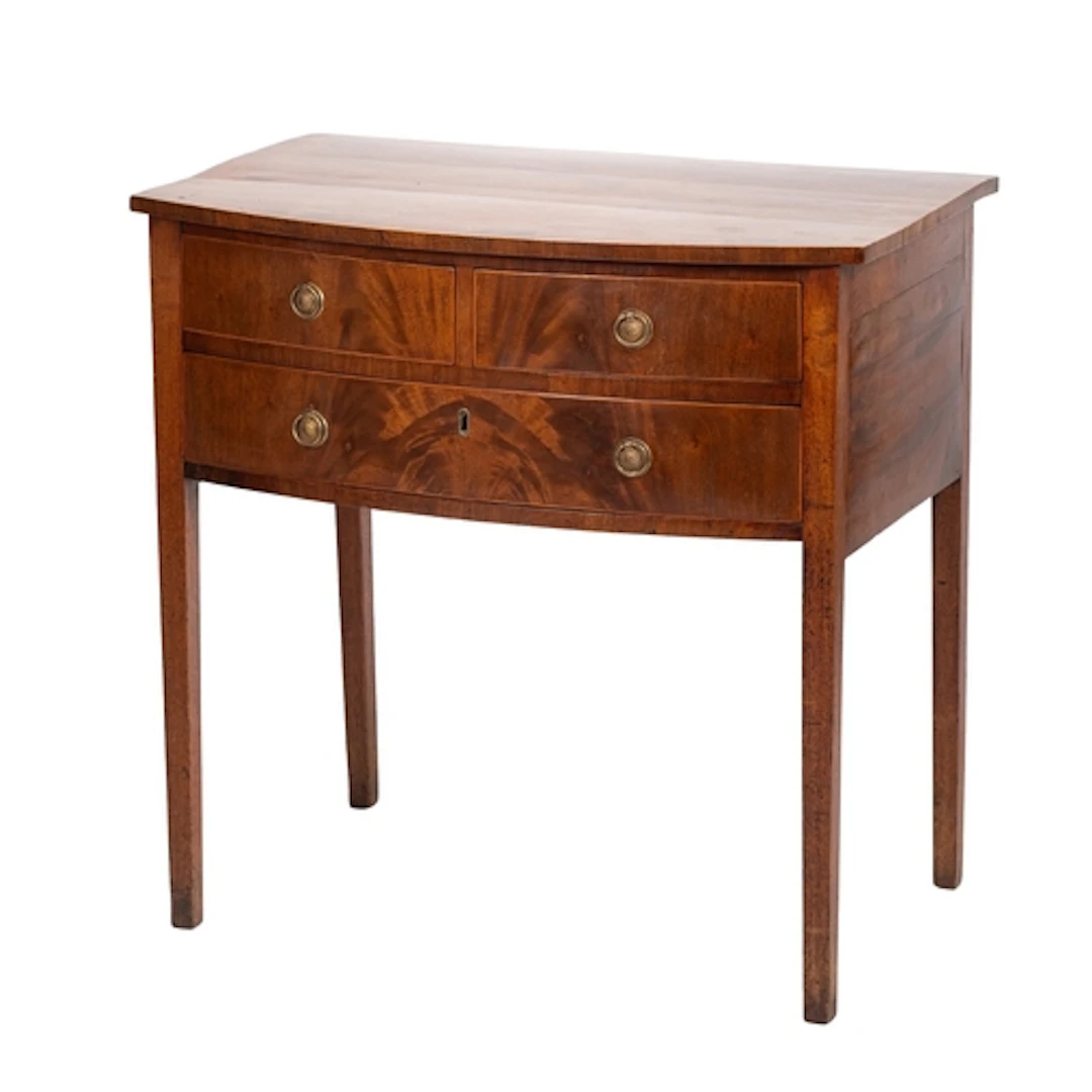 A mahogany and crossbanded bowfront side table in late Georg...