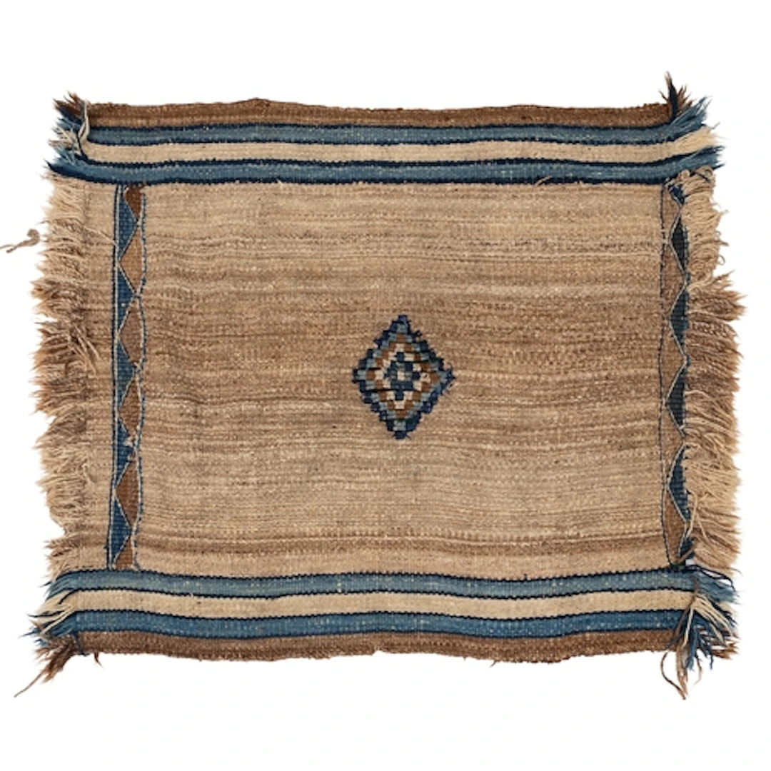 A Kurdish tribal rug, the brown/beige striped field with a c...