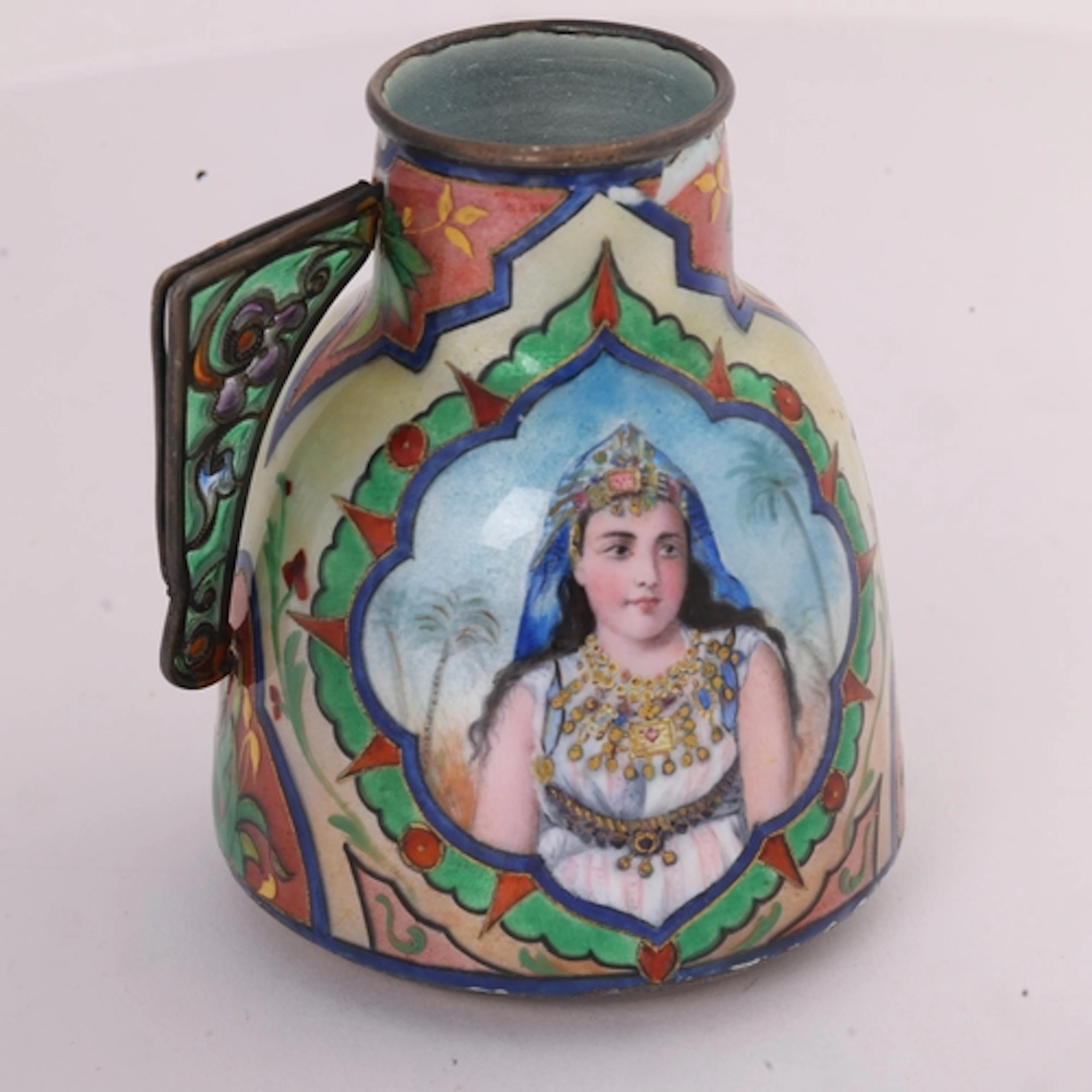 An Art Nouveau silver-gilt enamel Orientalist cream jug, han...