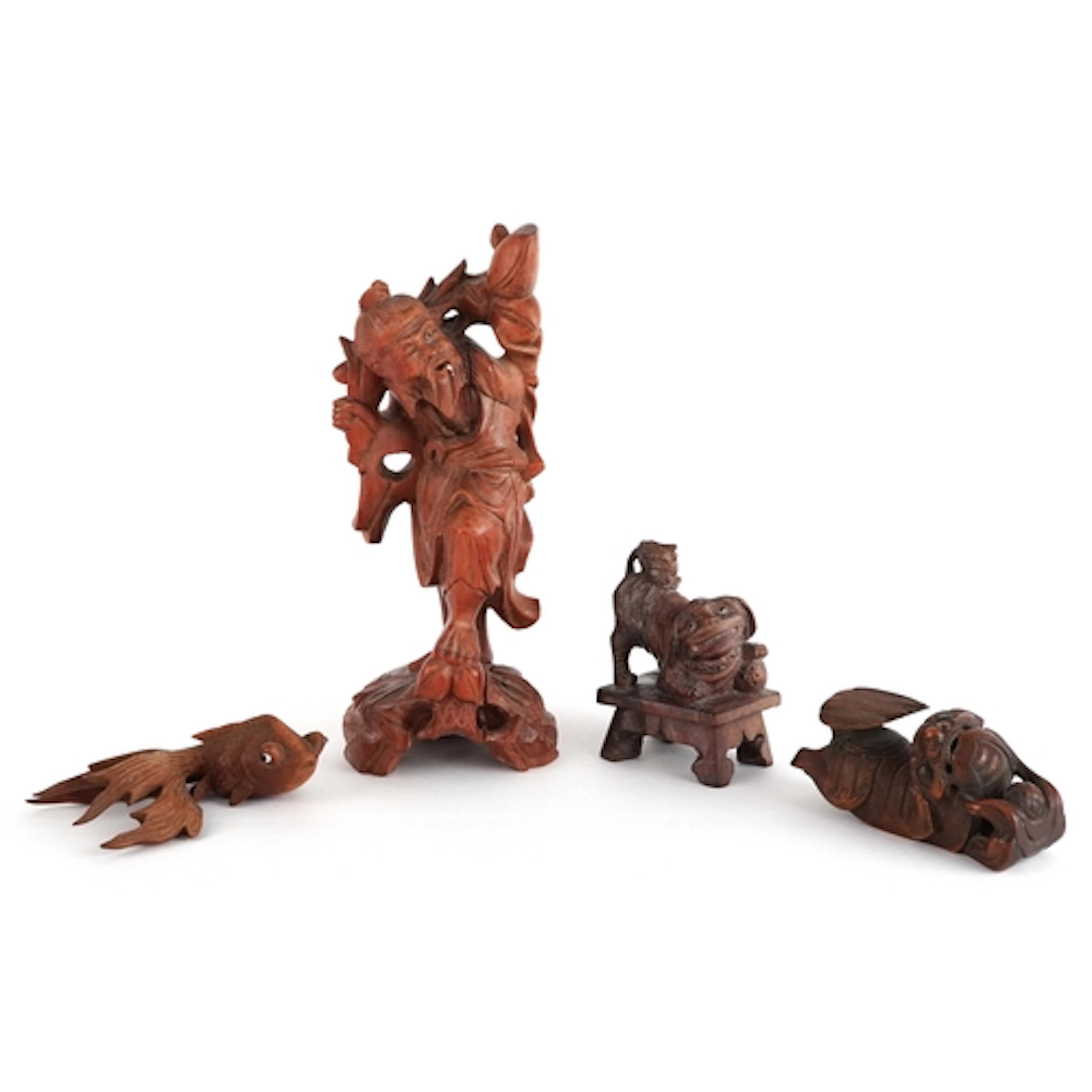 Four Chinese/Japanese wood carvings including a Koi, Shishi,...