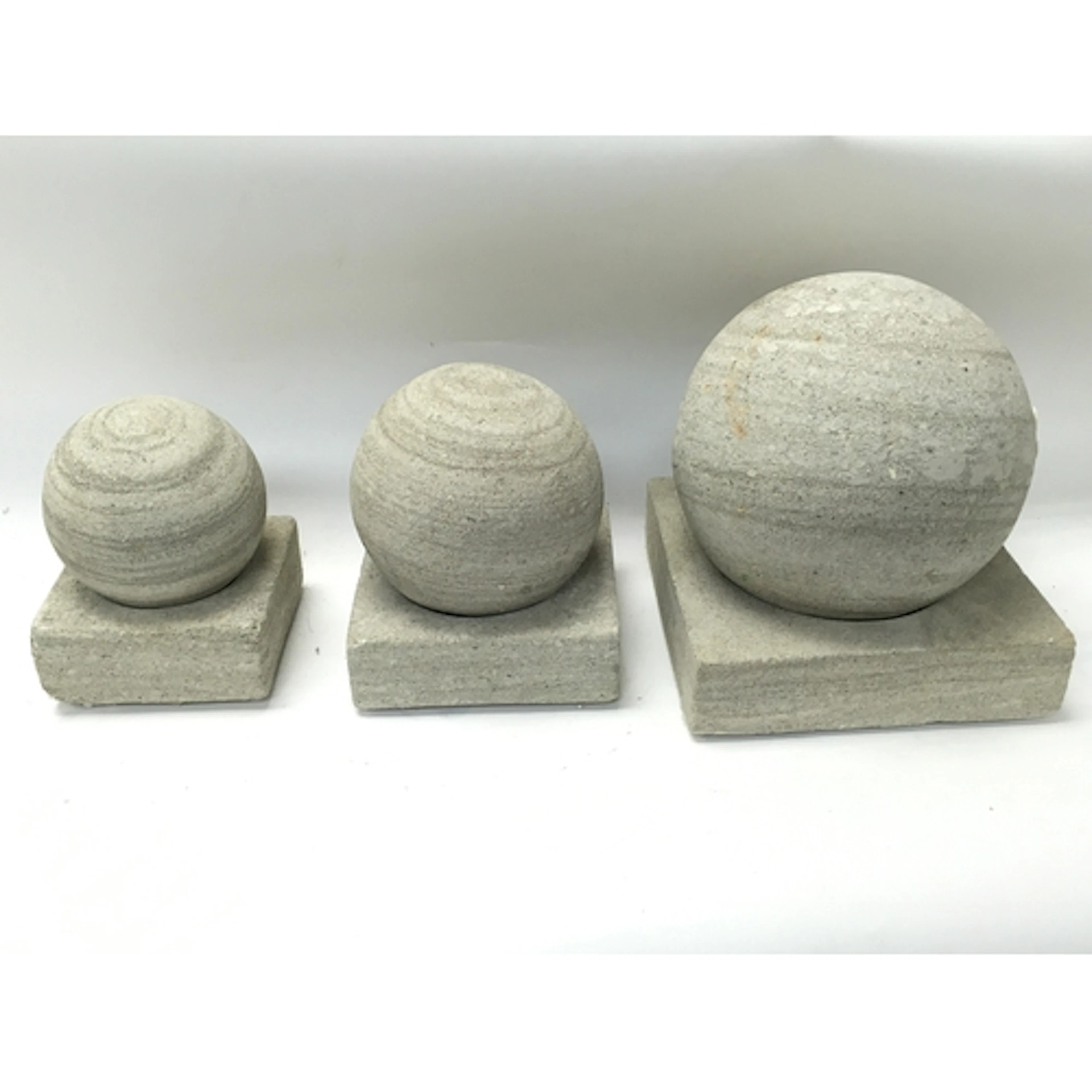 Three stone balls and plinths tallest Approx 23cm