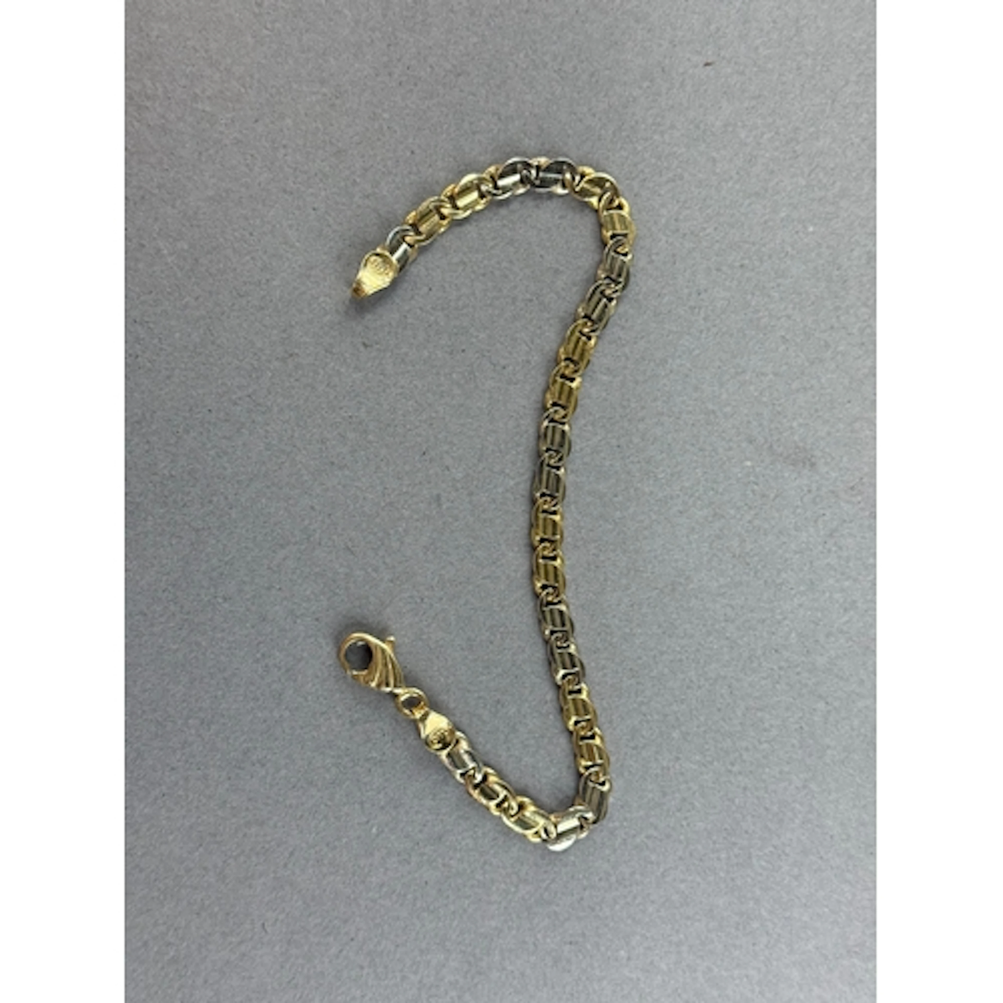 Jewellery: a yellow metal flattened curb link bracelet, Ital...