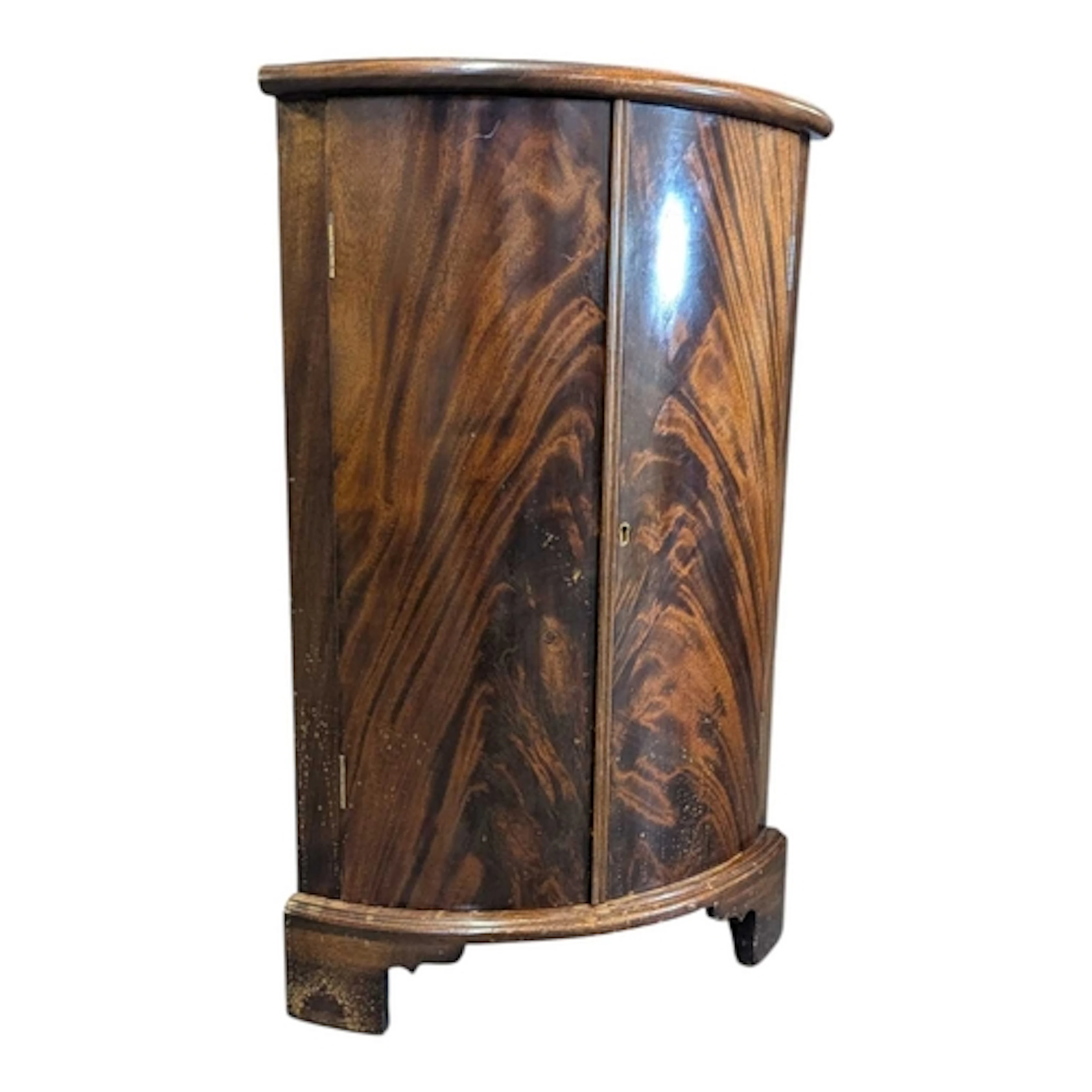 A 19th century George III flame mahogany corner cabinet. The...