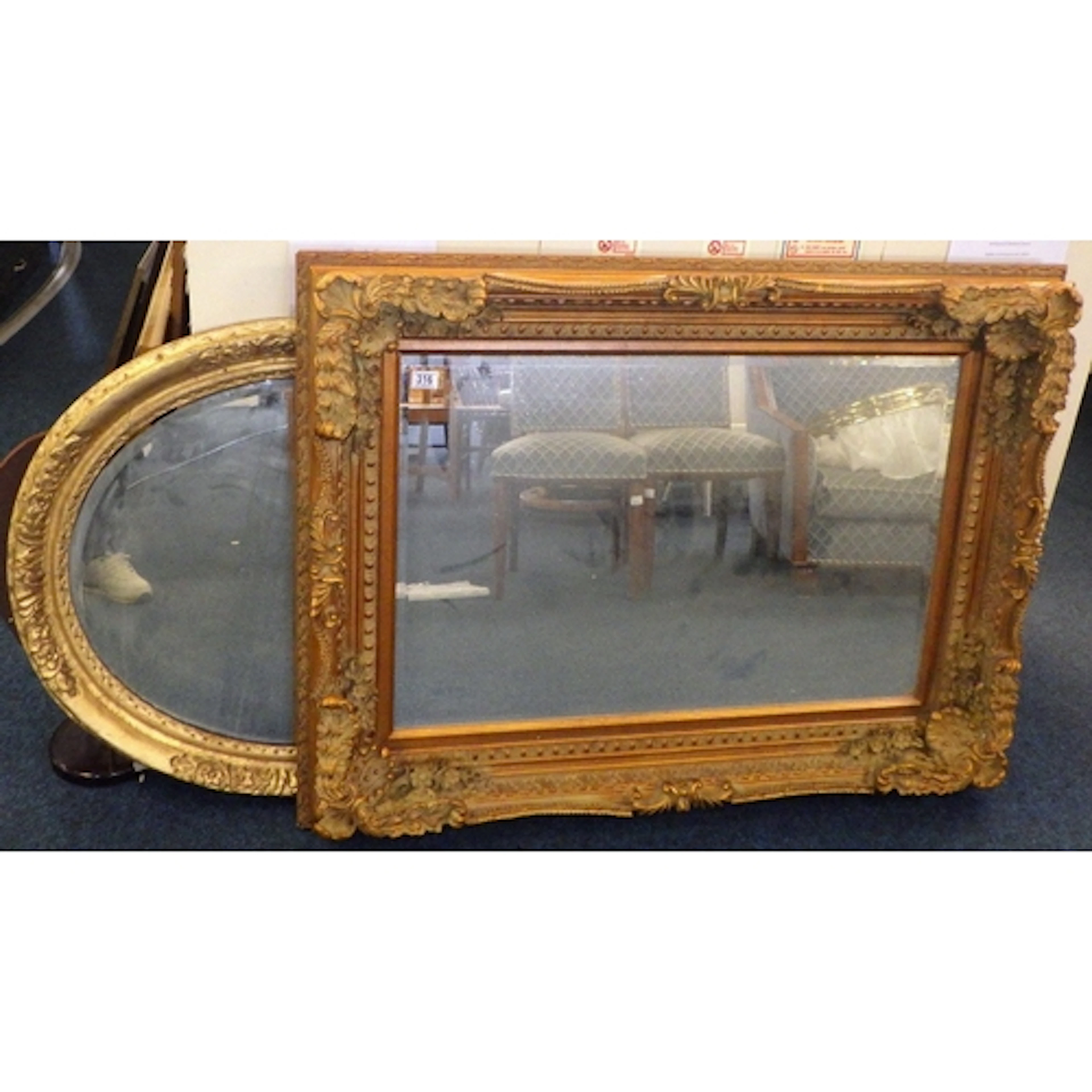 A large modern bevelled mirror together with a gilt framed o...