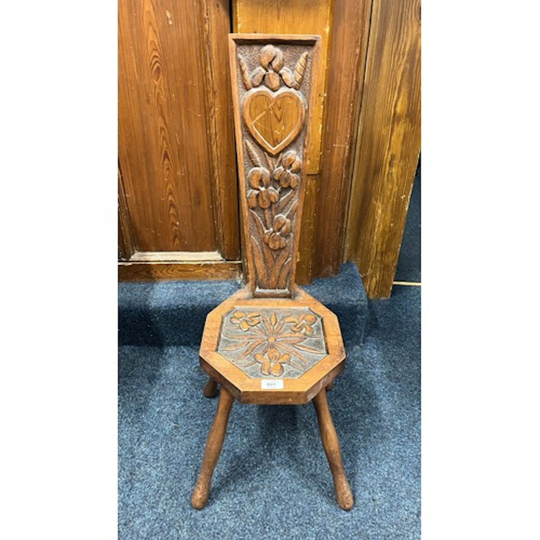Oak carved spinning chair with heart shaped cut out design.