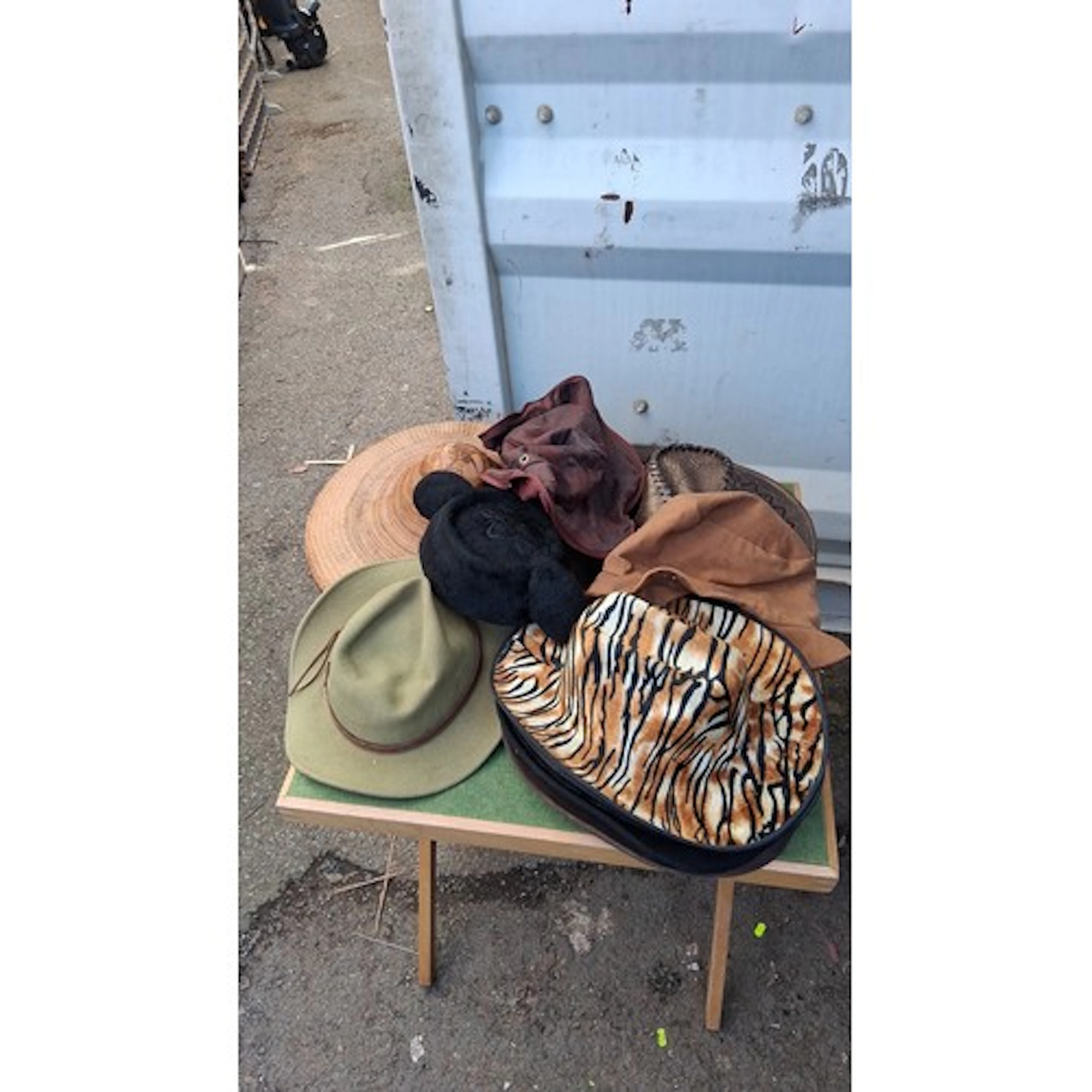 A group of hats and headwear, including felt cowboy hats, a ...