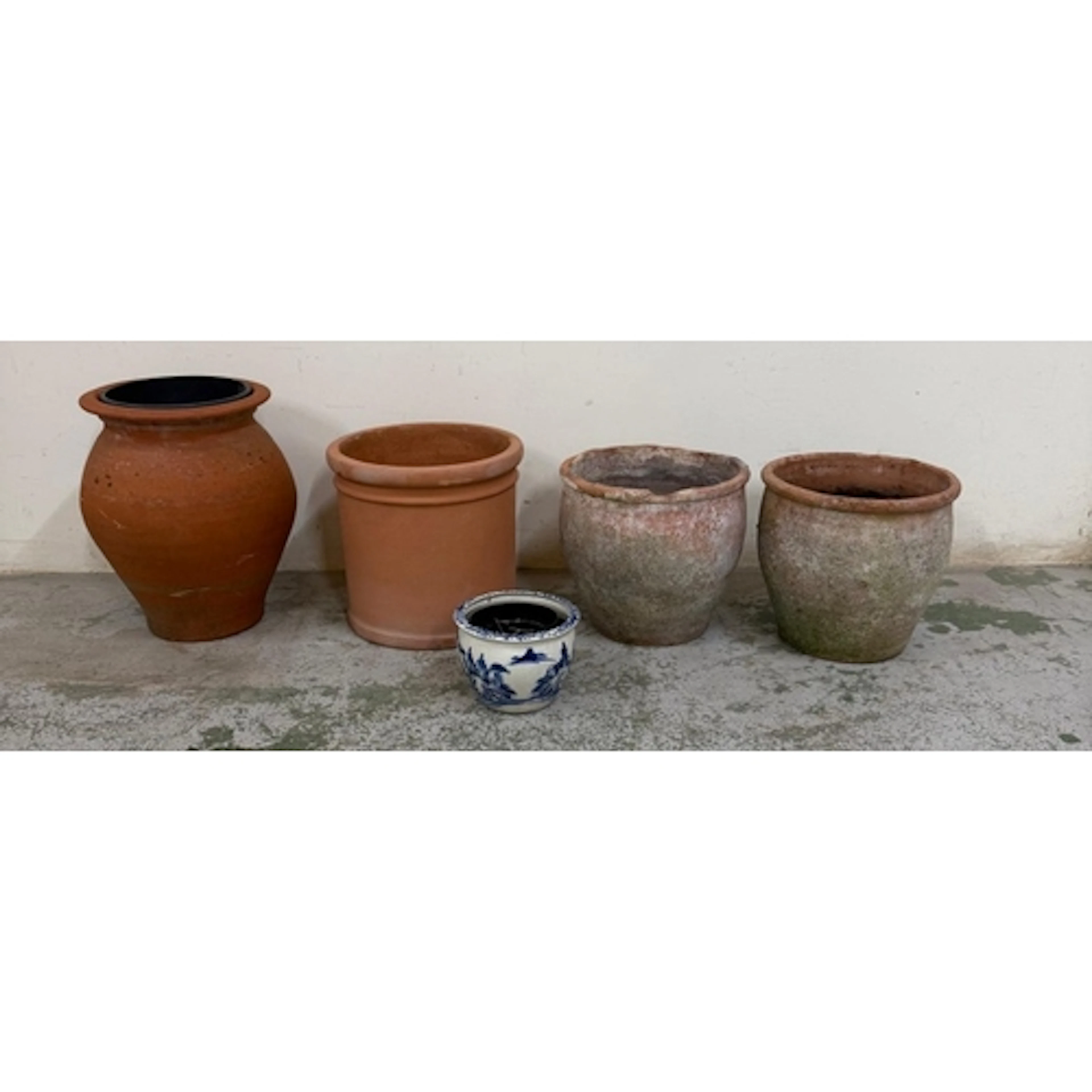 Four terracotta garden planters of various styles together w...