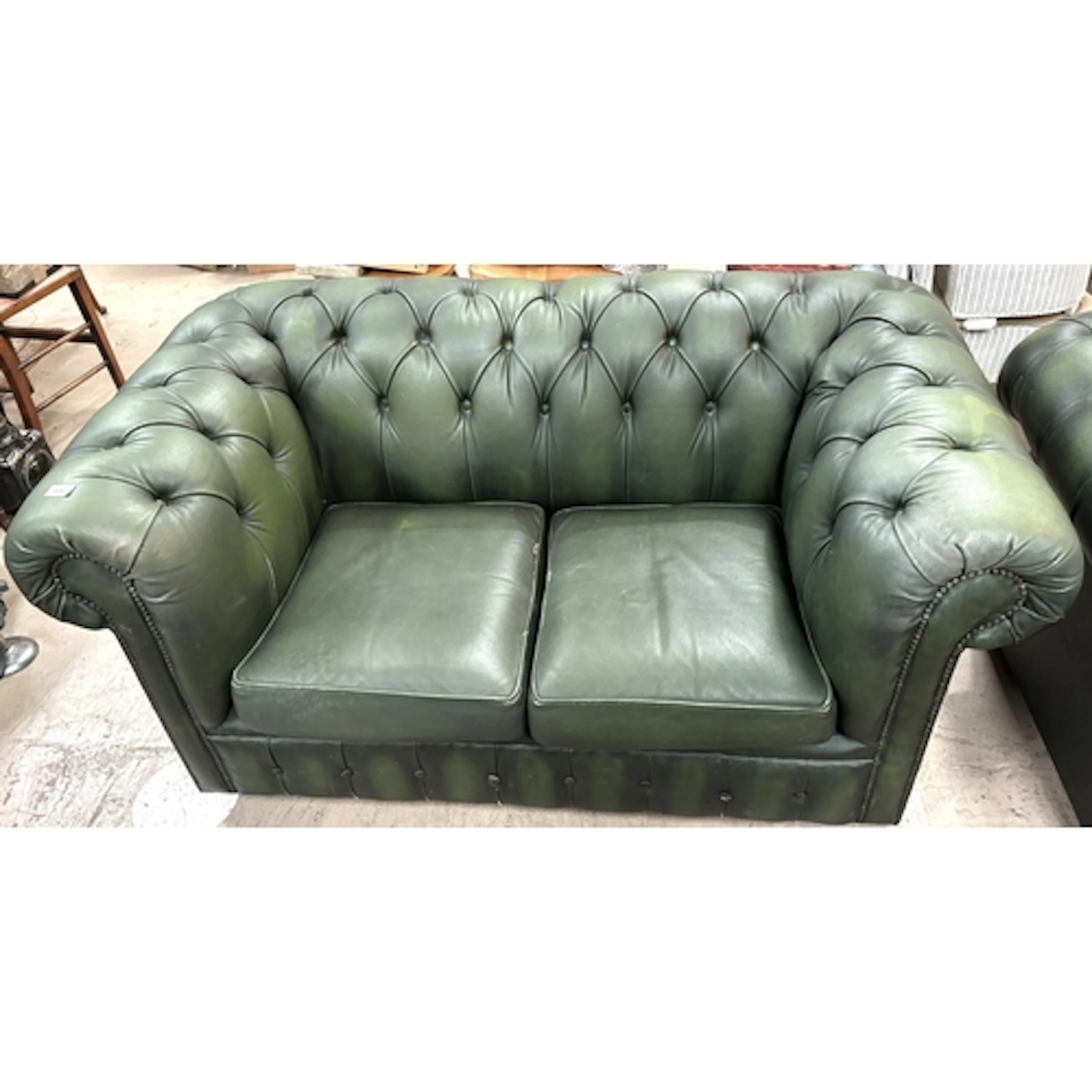 A deeply buttoned 2 seater Chesterfield in green.