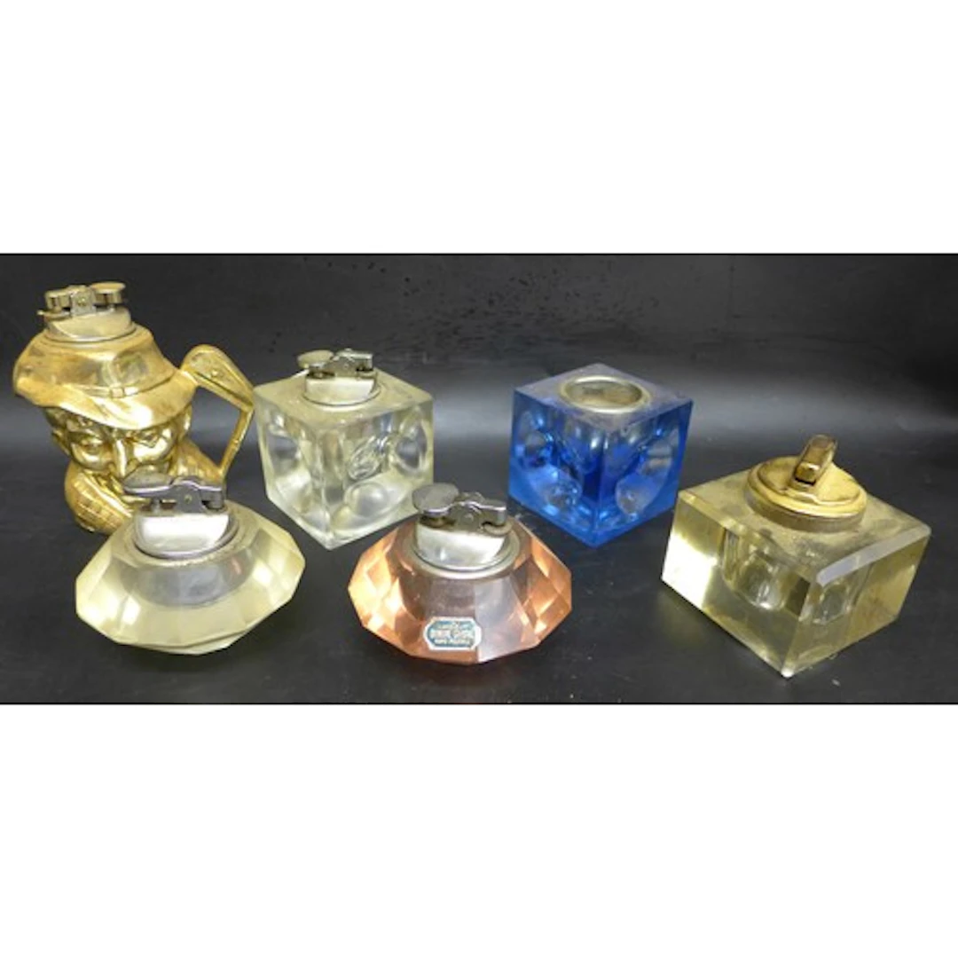 A Collection of table lighters - five glass and one novelty ...