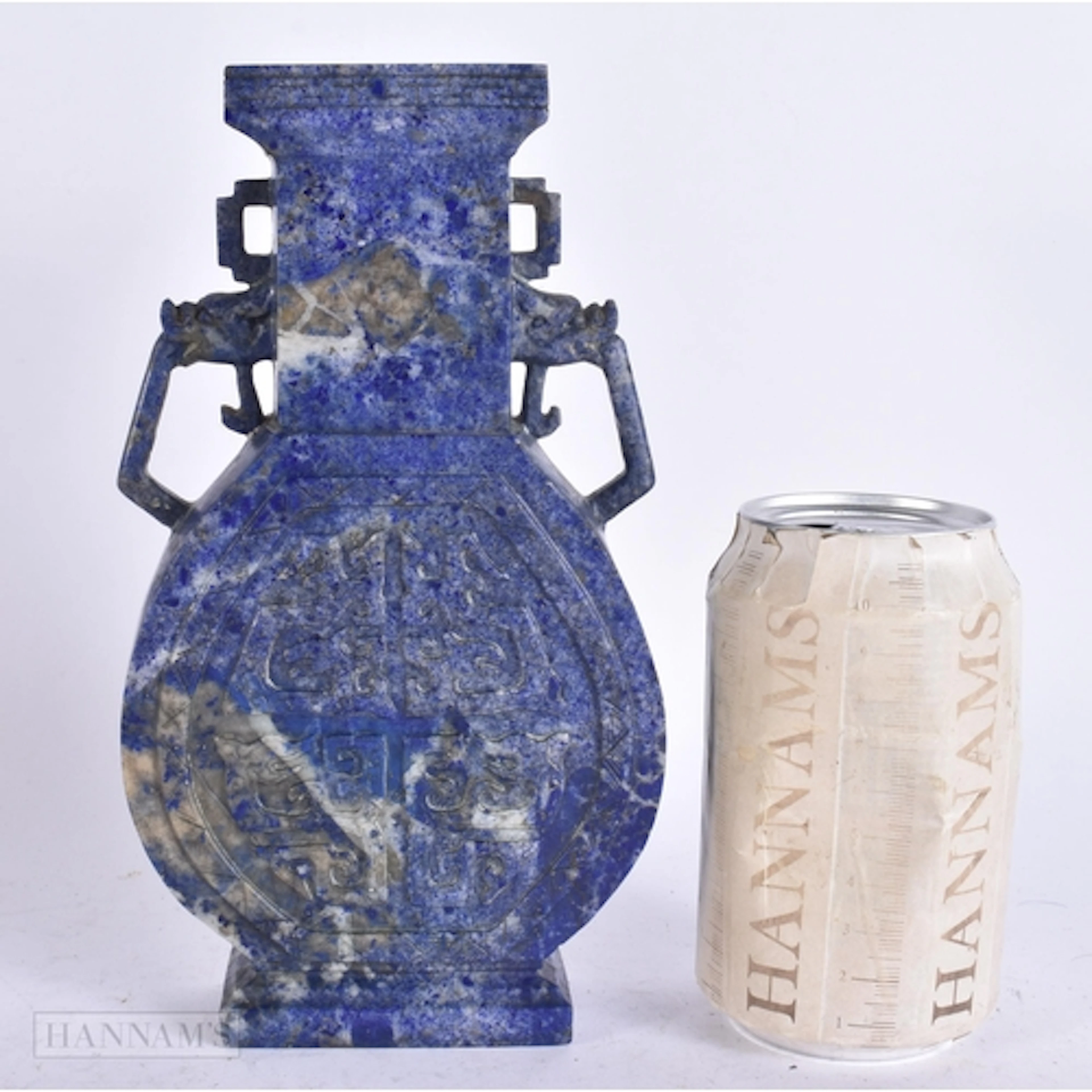 A CHINESE QING DYNASTY CARVED LAPIS LAZULI TWIN HANDLED VASE...
