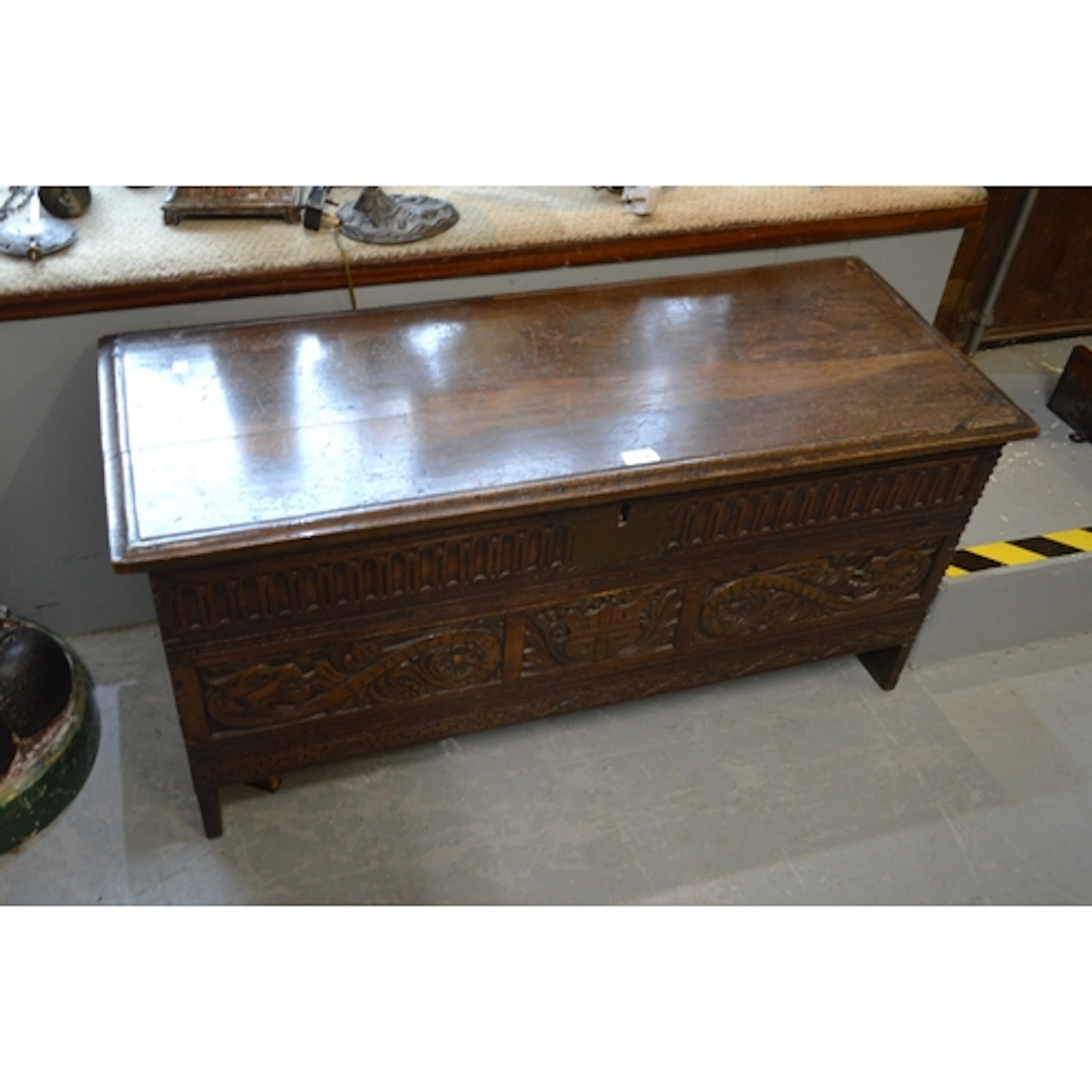 Antique oak plank coffer, the hinged moulded lid above a car...