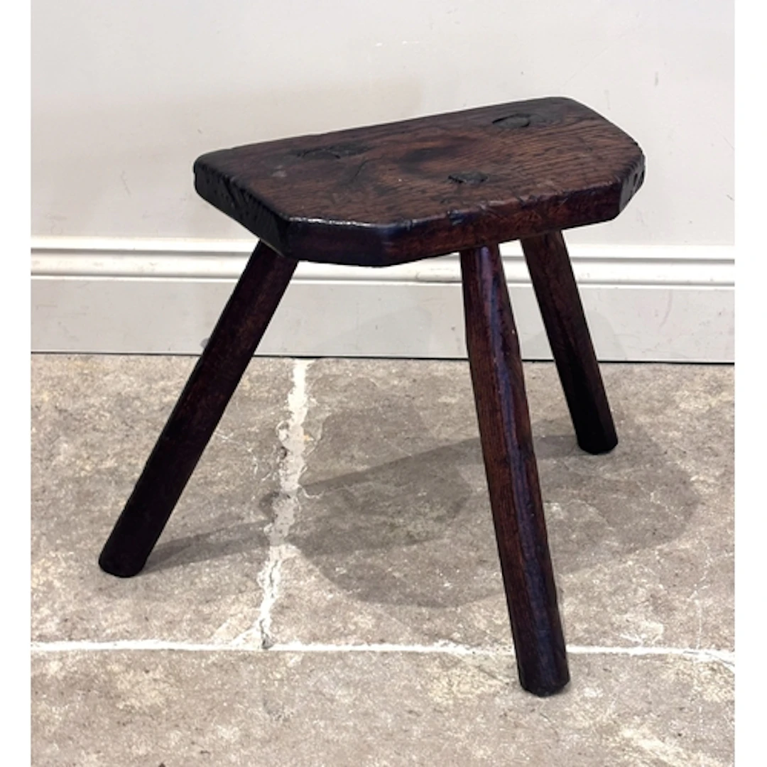 A 19th century primitive oak jointed milking stool, with thr...
