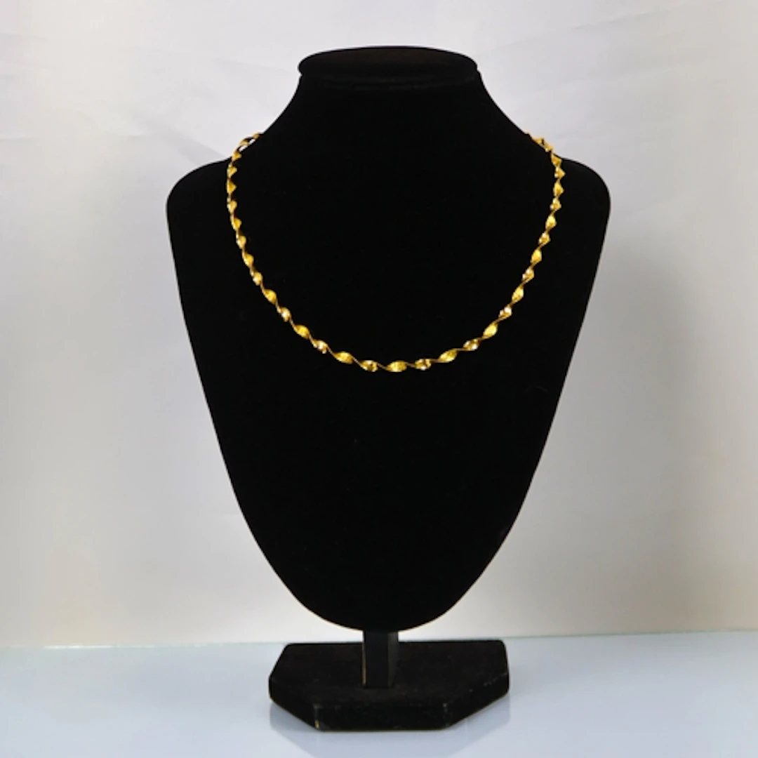 A contemporary 9ct gold necklace, possibly Italian, the twis...