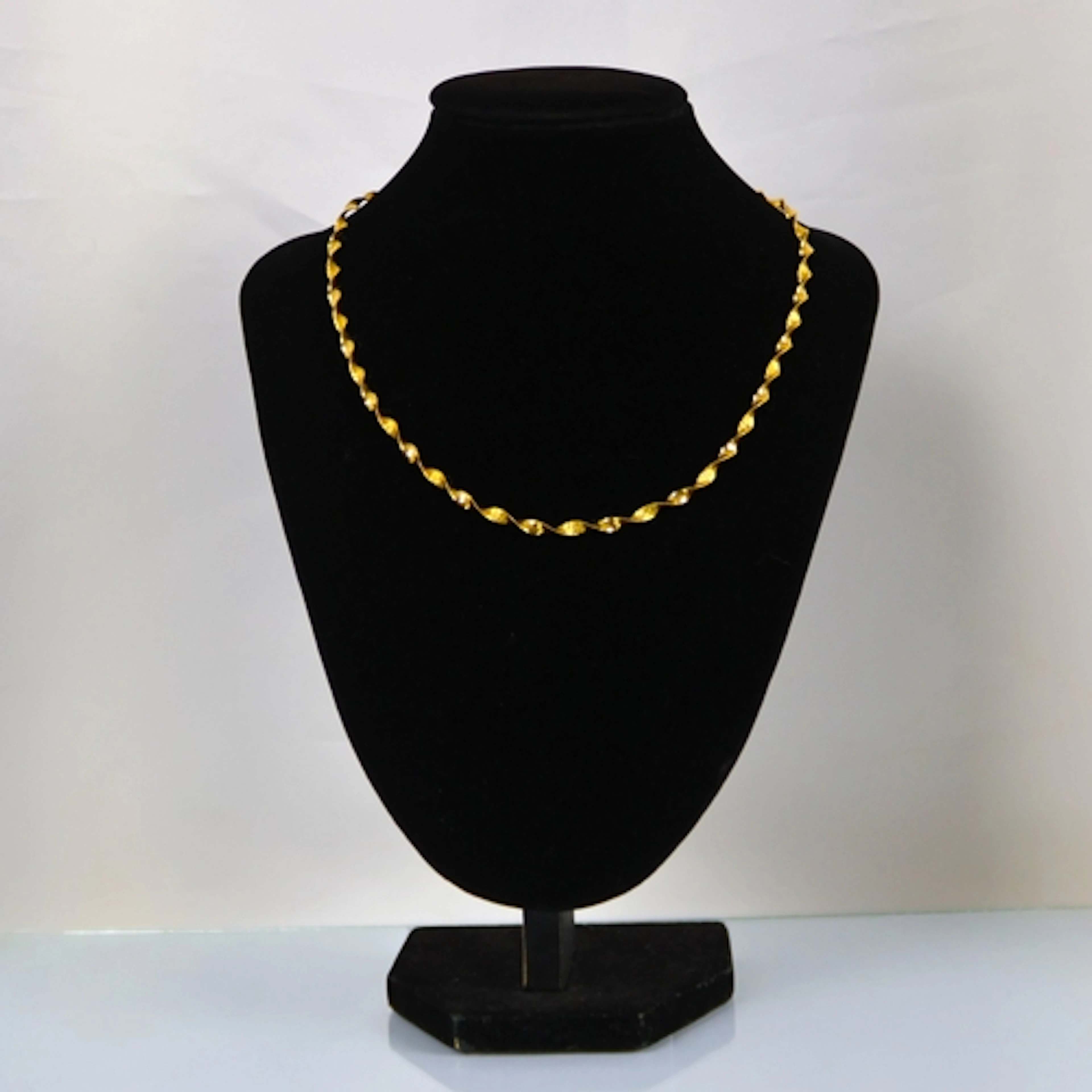 A contemporary 9ct gold necklace, possibly Italian, the twis...