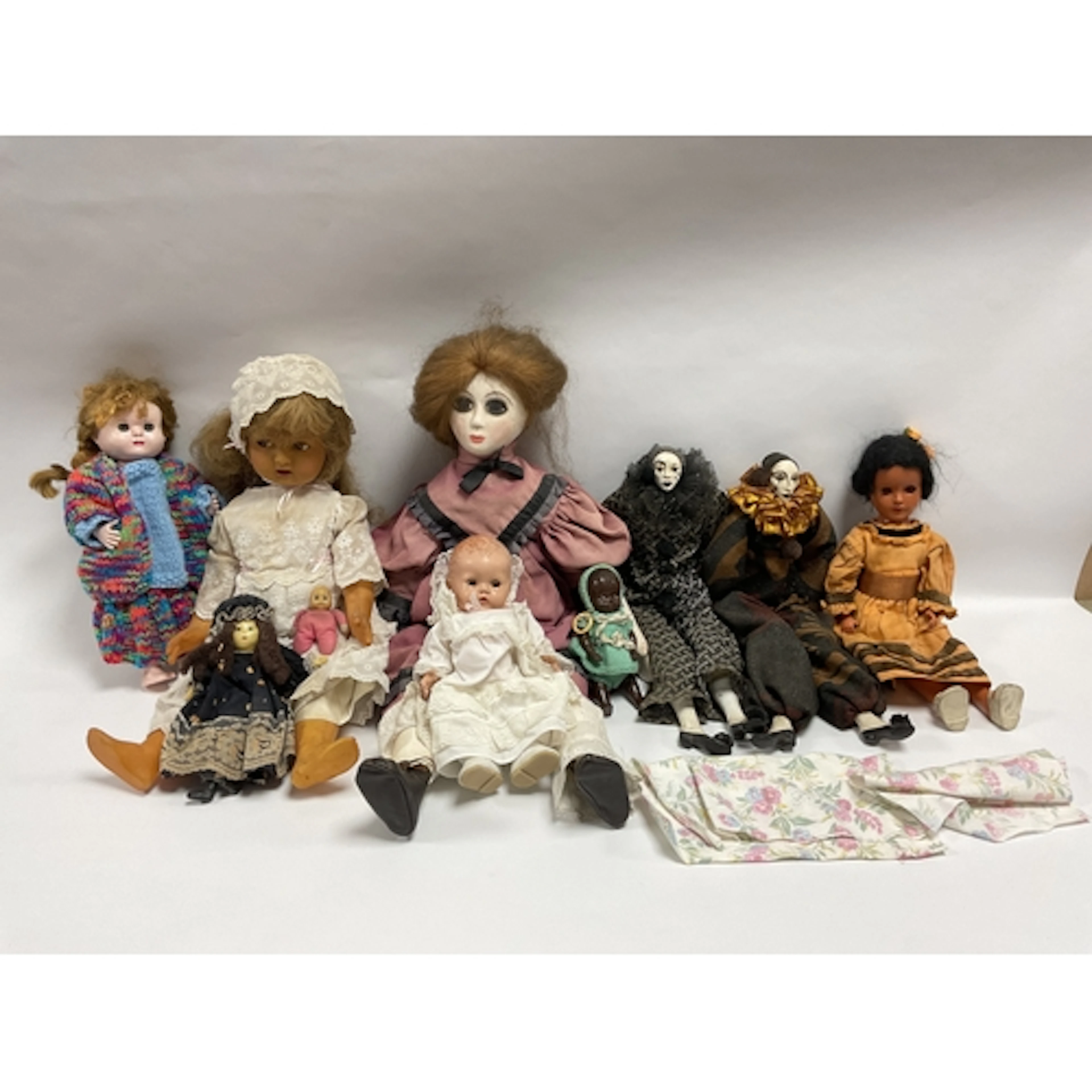 Ten plastic, wooden and porcelain dolls, to include a small ...