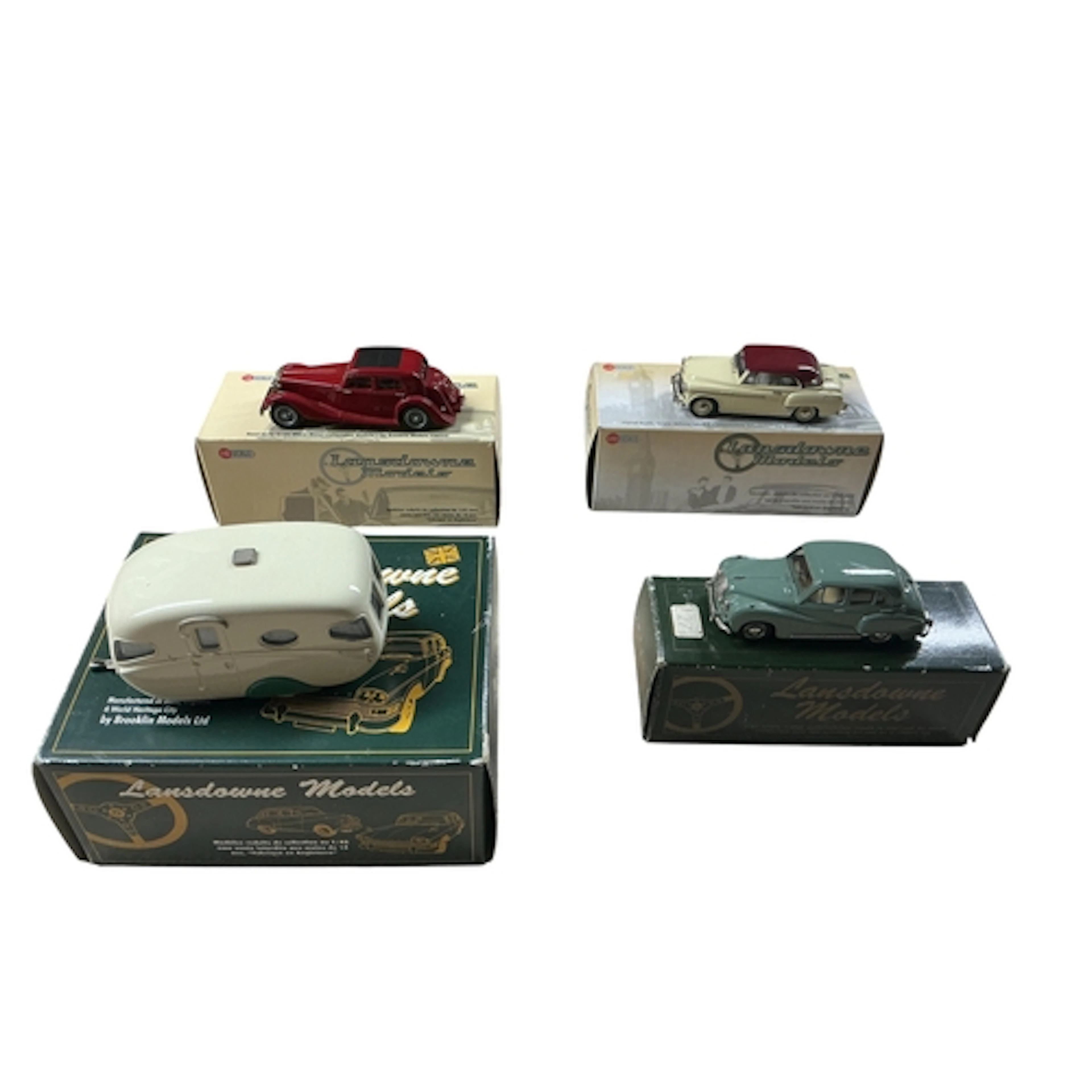 Four boxed 1:43 scale white metal models of cars and a carav...