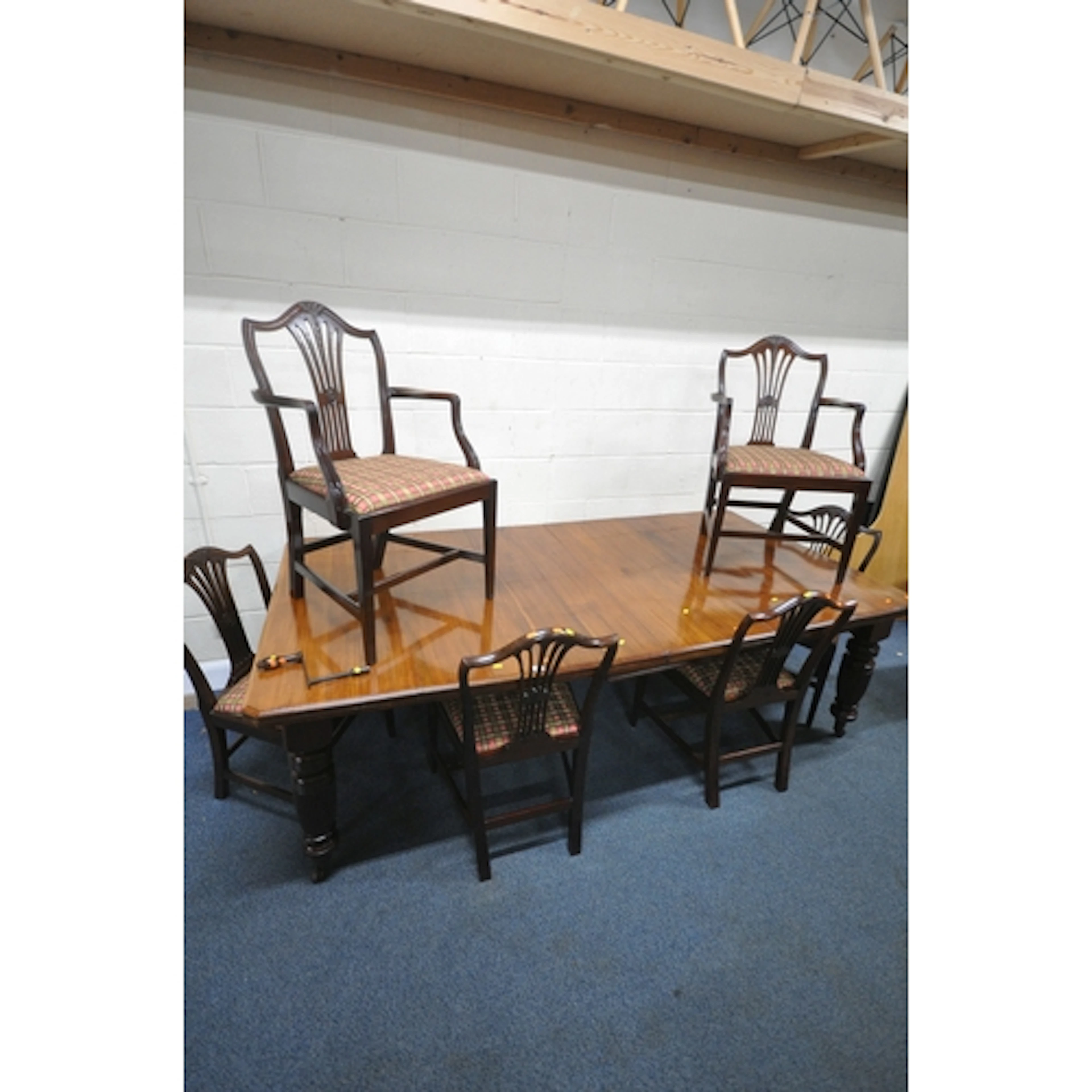 A LATE VICTORIAN MAHOGANY WIND OUT DINING TABLE, with two ad...