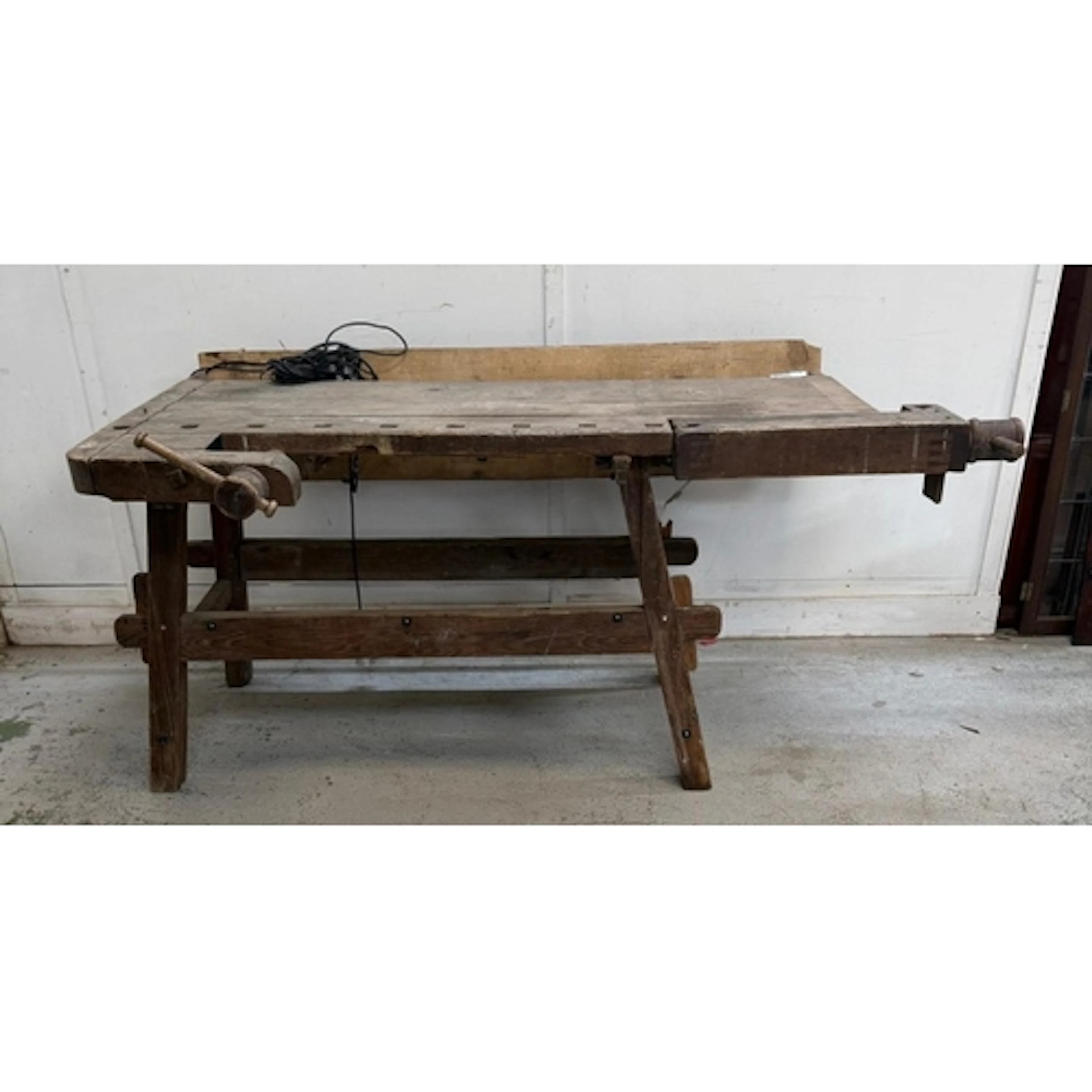 A vintage pine work bench with two vises