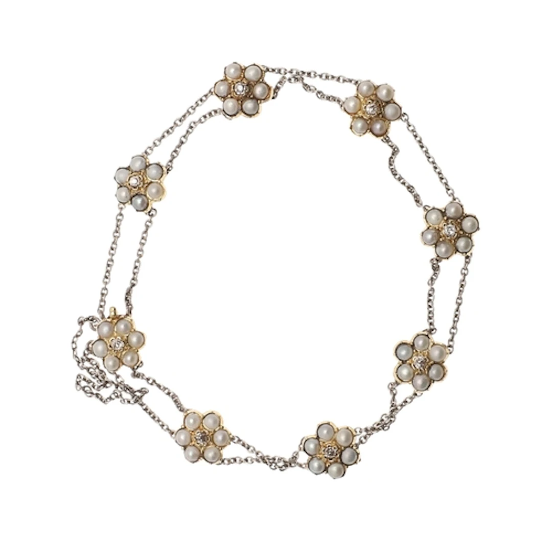 AN EARLY TWENTIETH CENTURY PEARL AND DIAMOND CLUSTER BRACELE...