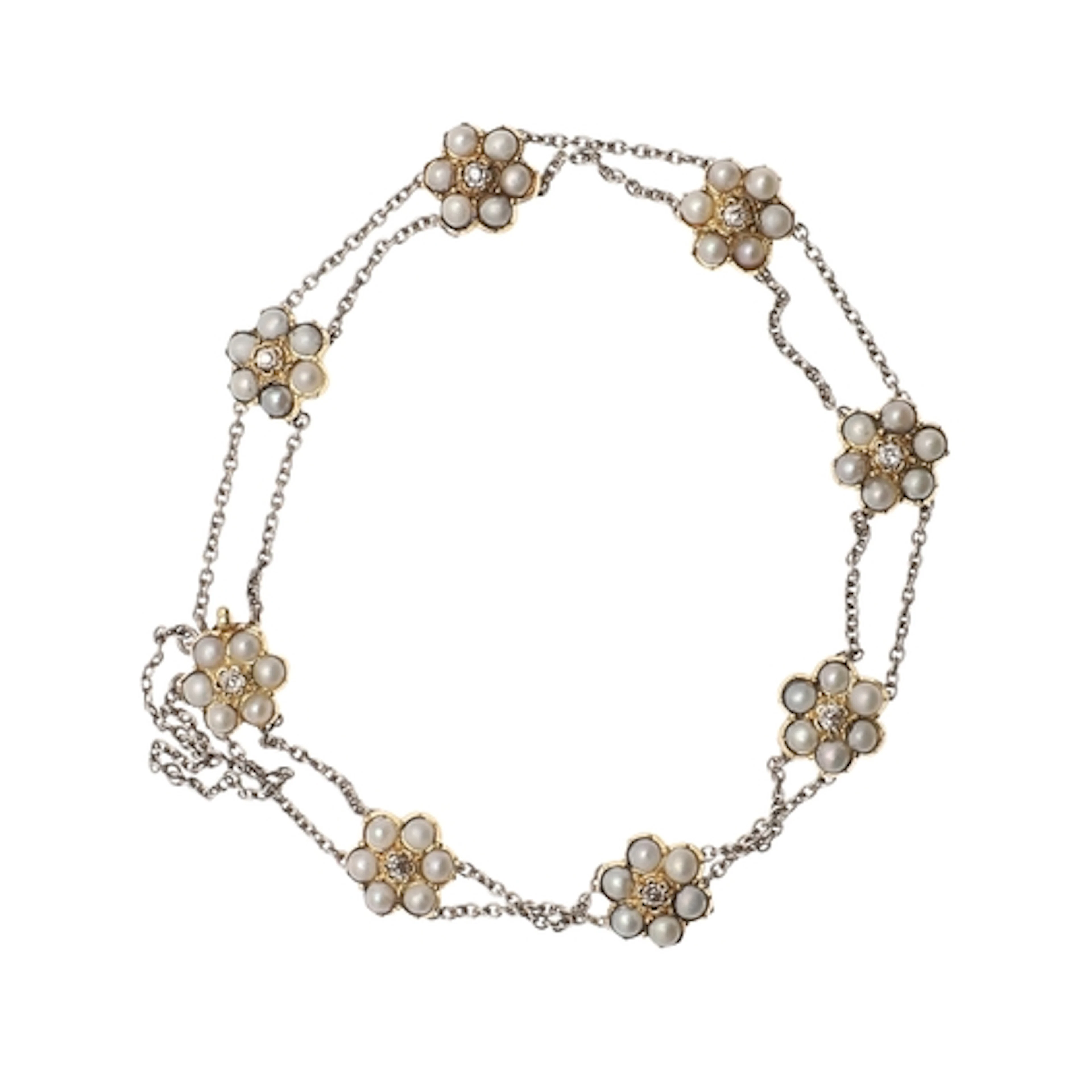 AN EARLY TWENTIETH CENTURY PEARL AND DIAMOND CLUSTER BRACELE...