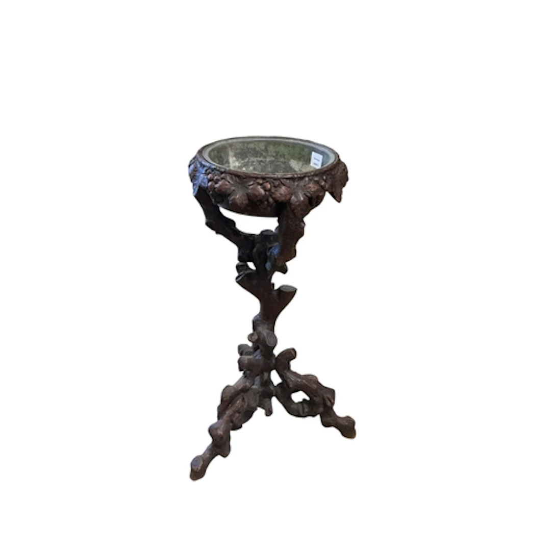 A Black Forest jardiniere table, diameter 50cm, height 82cm...