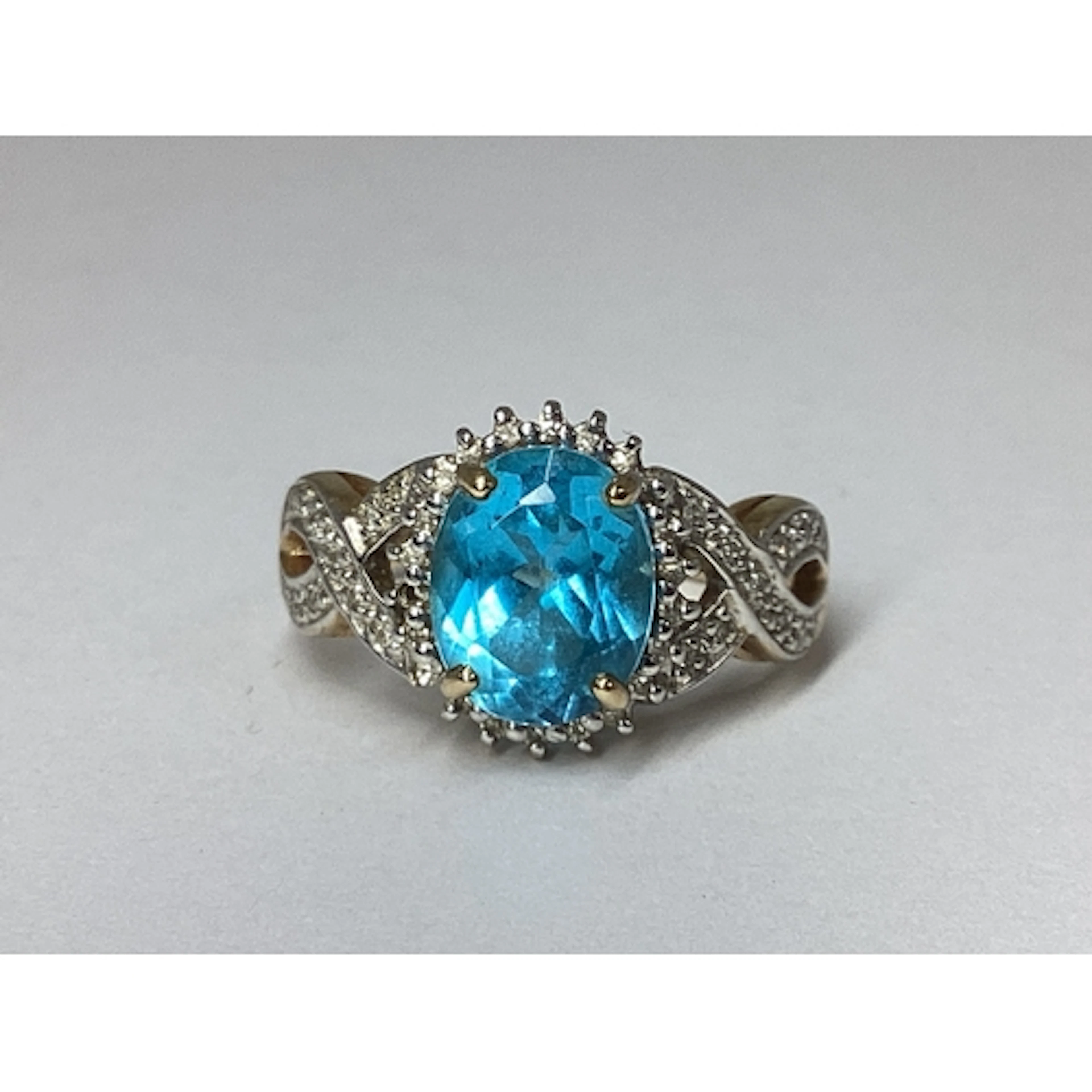 A Decorative Claw Set Cluster Ring, the oval centre stone wi...