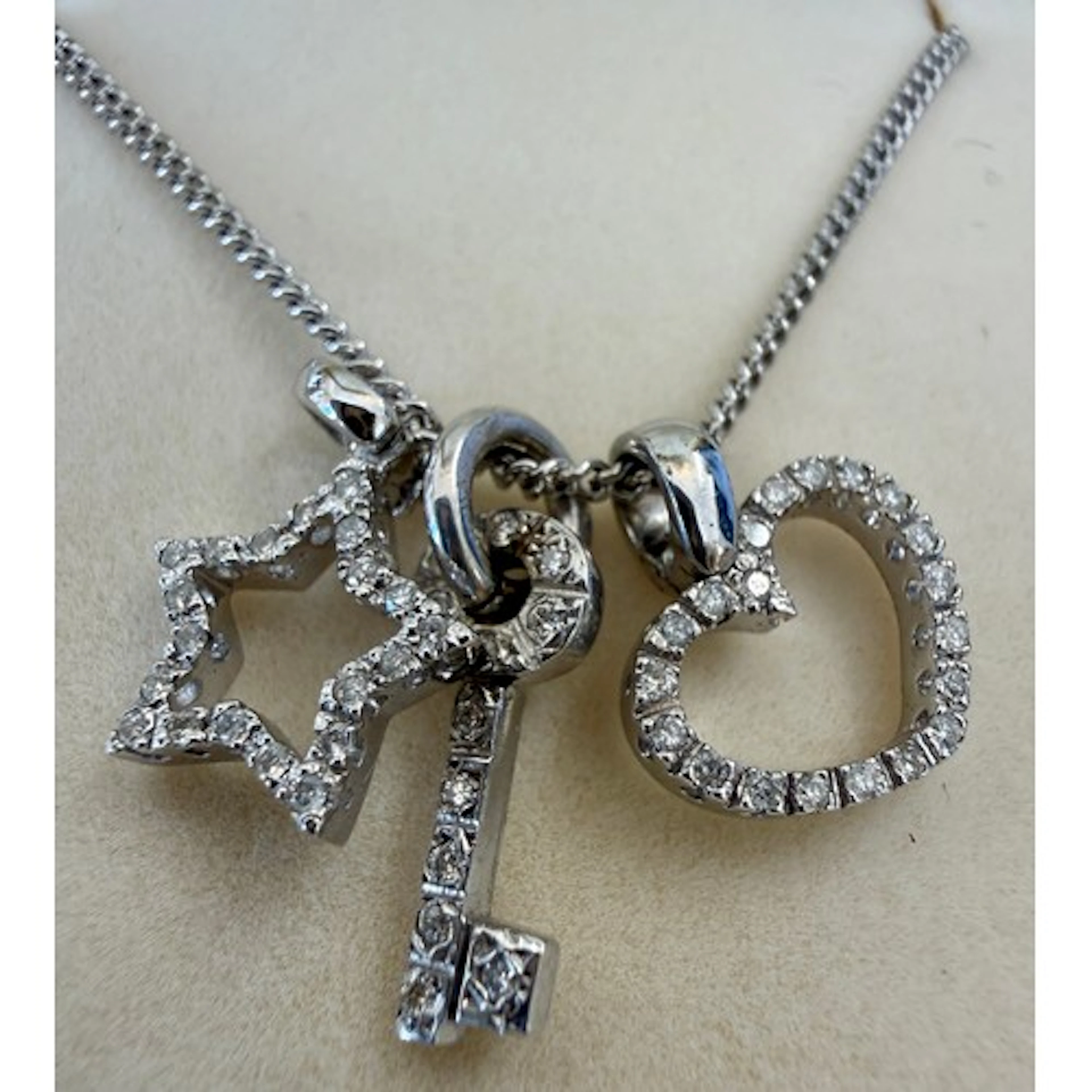 A 9 carat white gold chain with three 9 carat gold diamond s...
