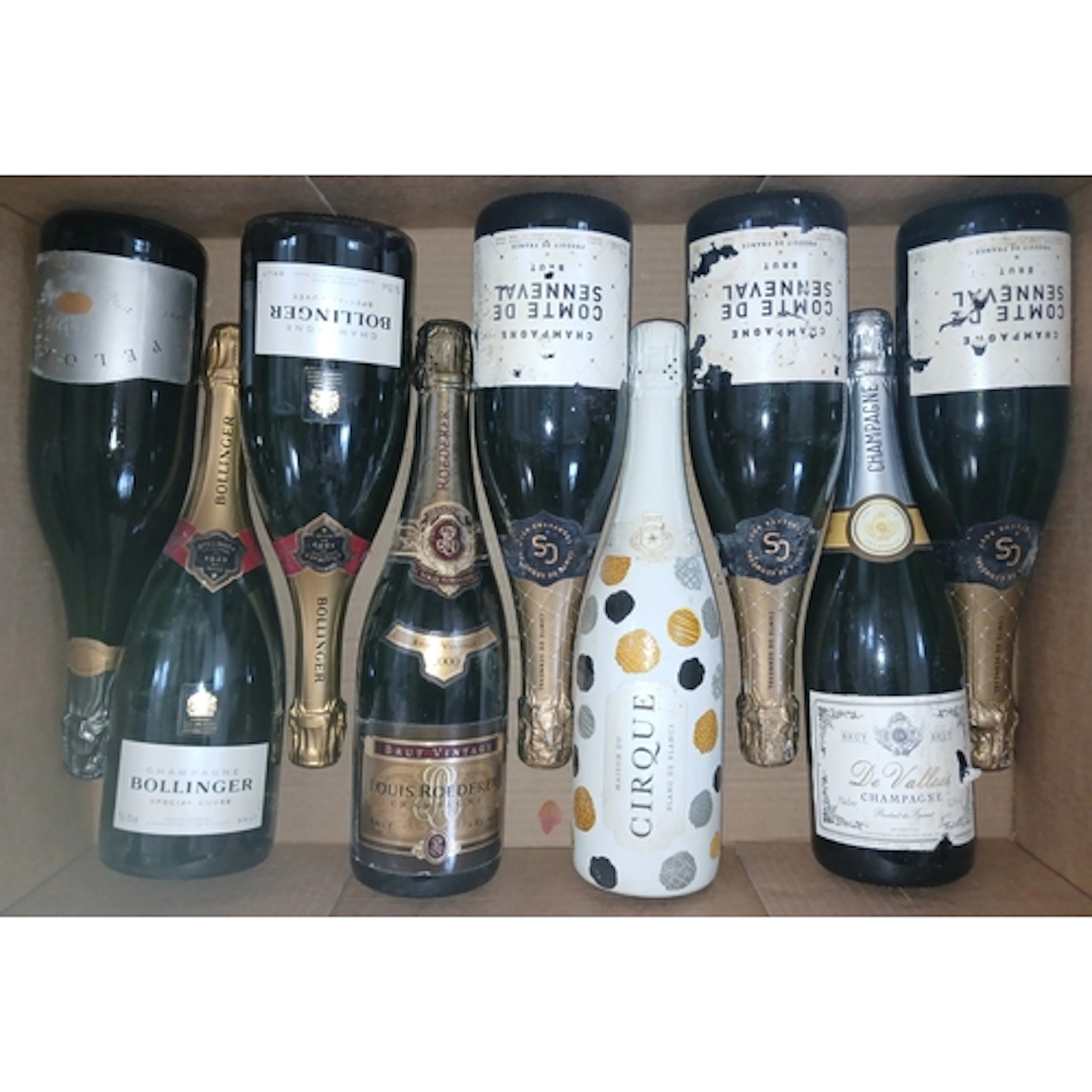 Nine bottles of assorted sparkling wine.