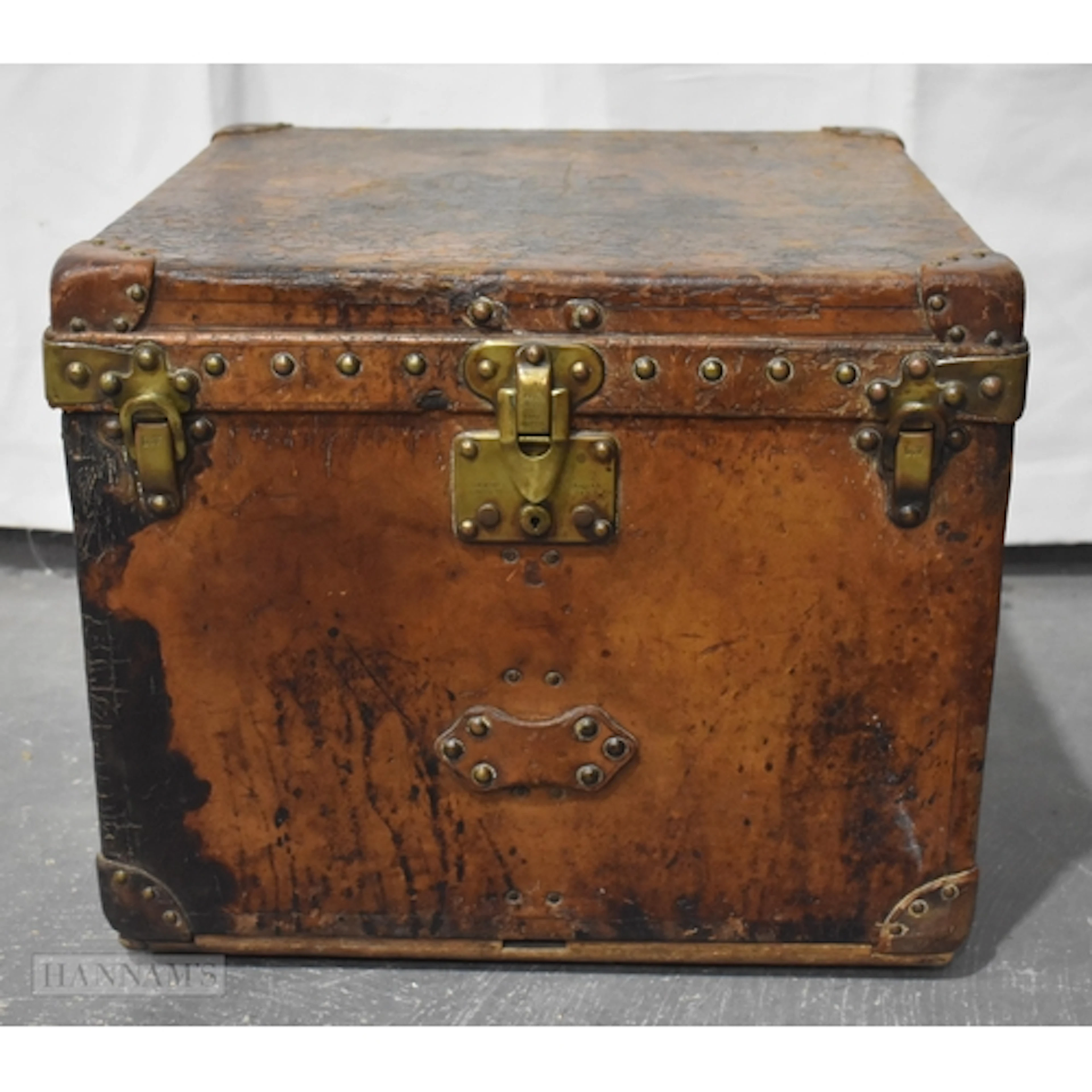 AN UNUSUAL LOUIS VUITTON LEATHER SQUARE FORM TRUNK bearing i...
