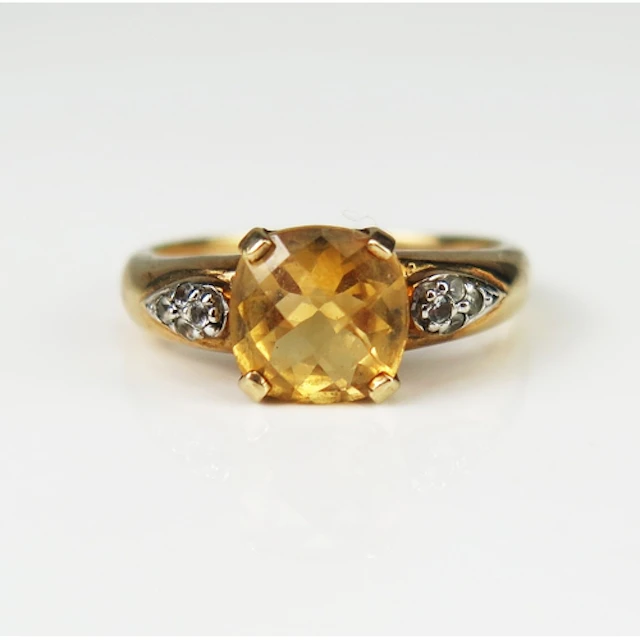 A citrine and white gem set dress ring in a 9ct yellow gold ...