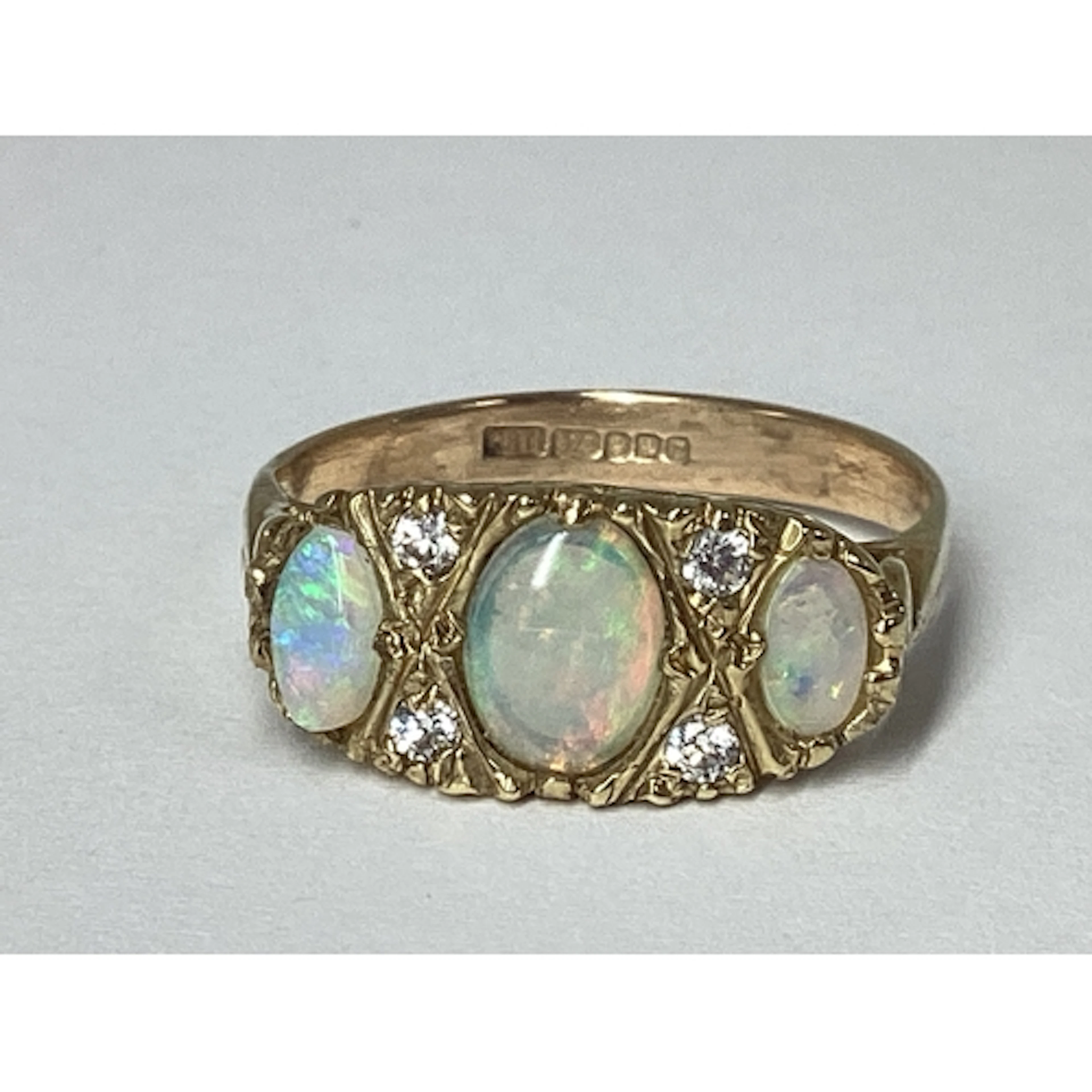 A 9ct Gold Graduated Three Stone Opal Ring, claw set, with h...