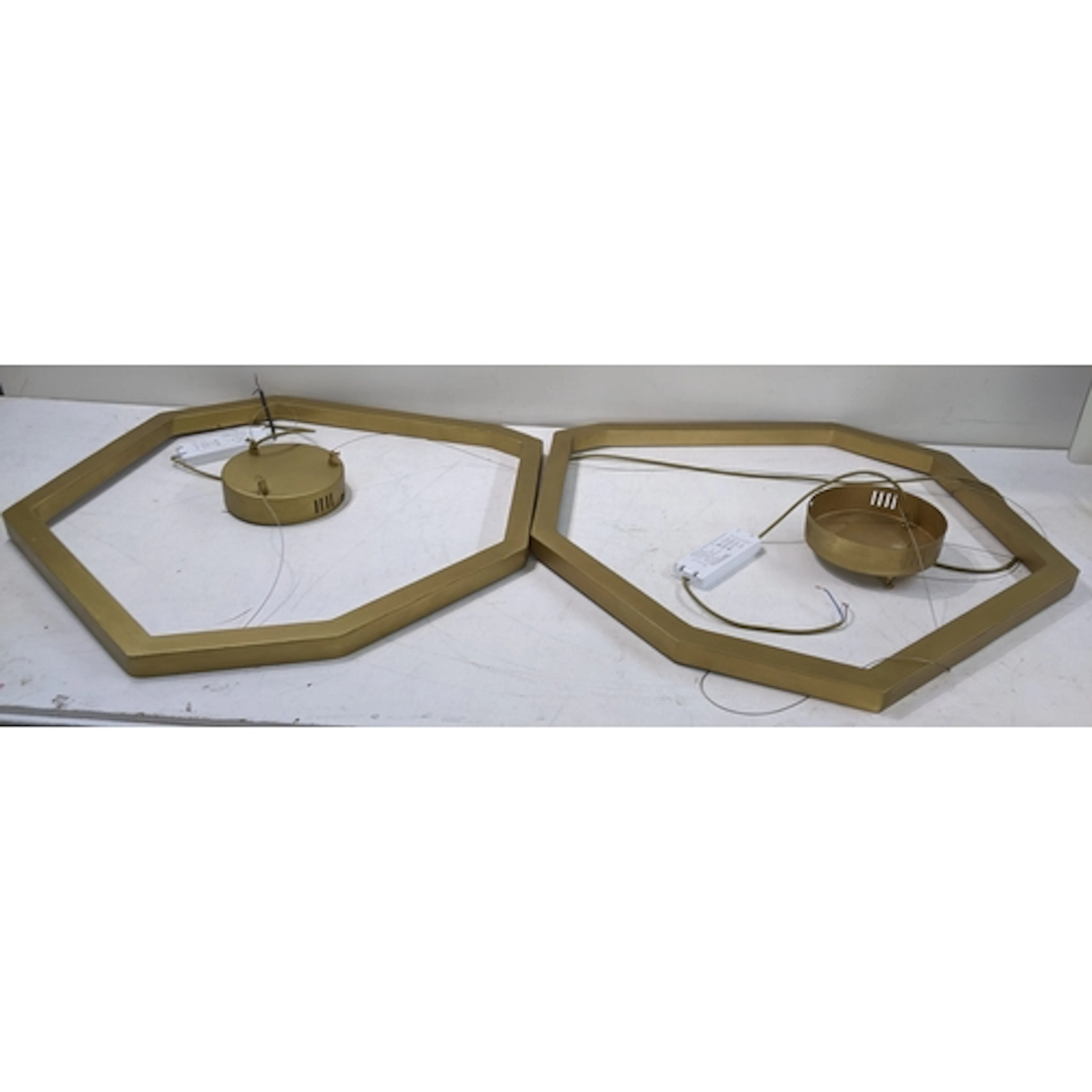 A pair of Eichholtz contemporary heptagon formed chandeliers...
